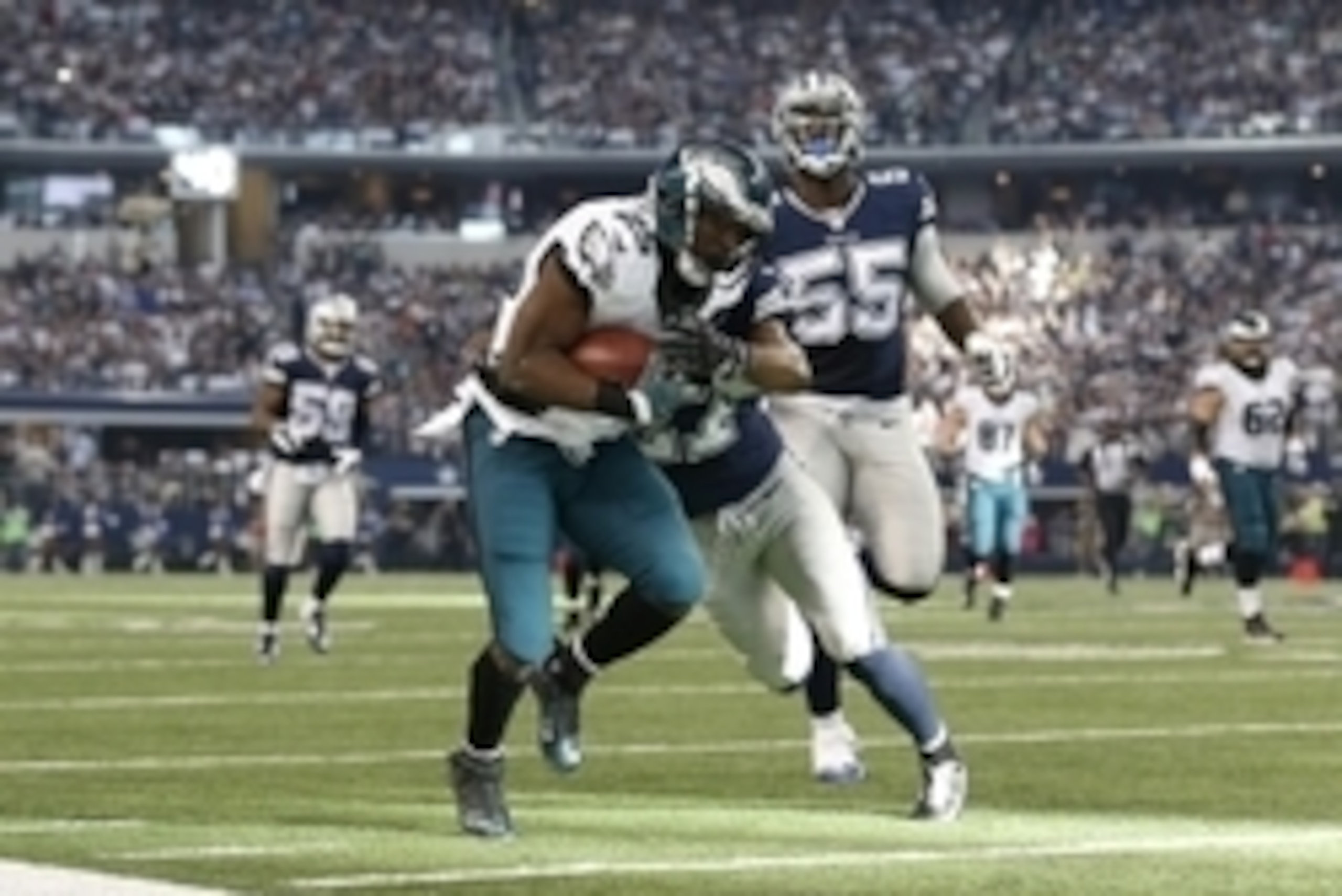 Nov 27, 2014; Arlington, TX, USA; Philadelphia Eagles running back LeSean McCoy (25) runs with the ball in the first quarter against Dallas Cowboys safety J.J. Wilcox (27) at AT&T Stadium. Mandatory Credit: Matthew Emmons-USA TODAY Sports