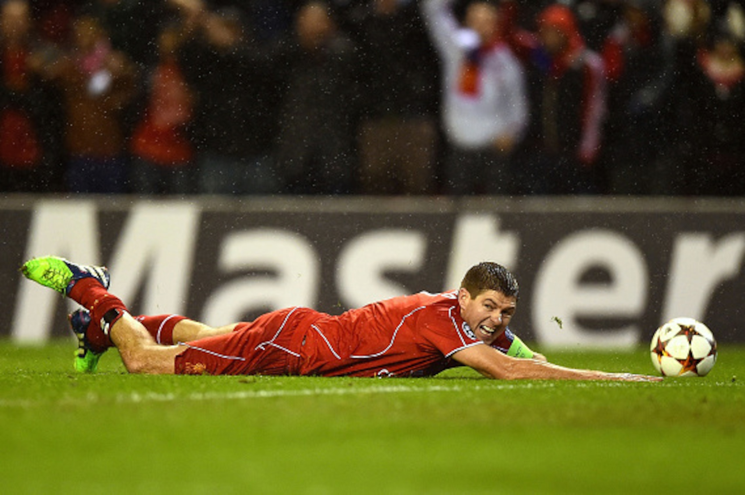 LIVERPOOL, ENGLAND - DECEMBER 09:  Steven Gerrard of Liverpool goes down in the down in the area during the UEFA Champions League group B match between Liverpool and FC Basel 1893 at Anfield on December 9, 2014 in Liverpool, United Kingdom.  (Photo by Lau