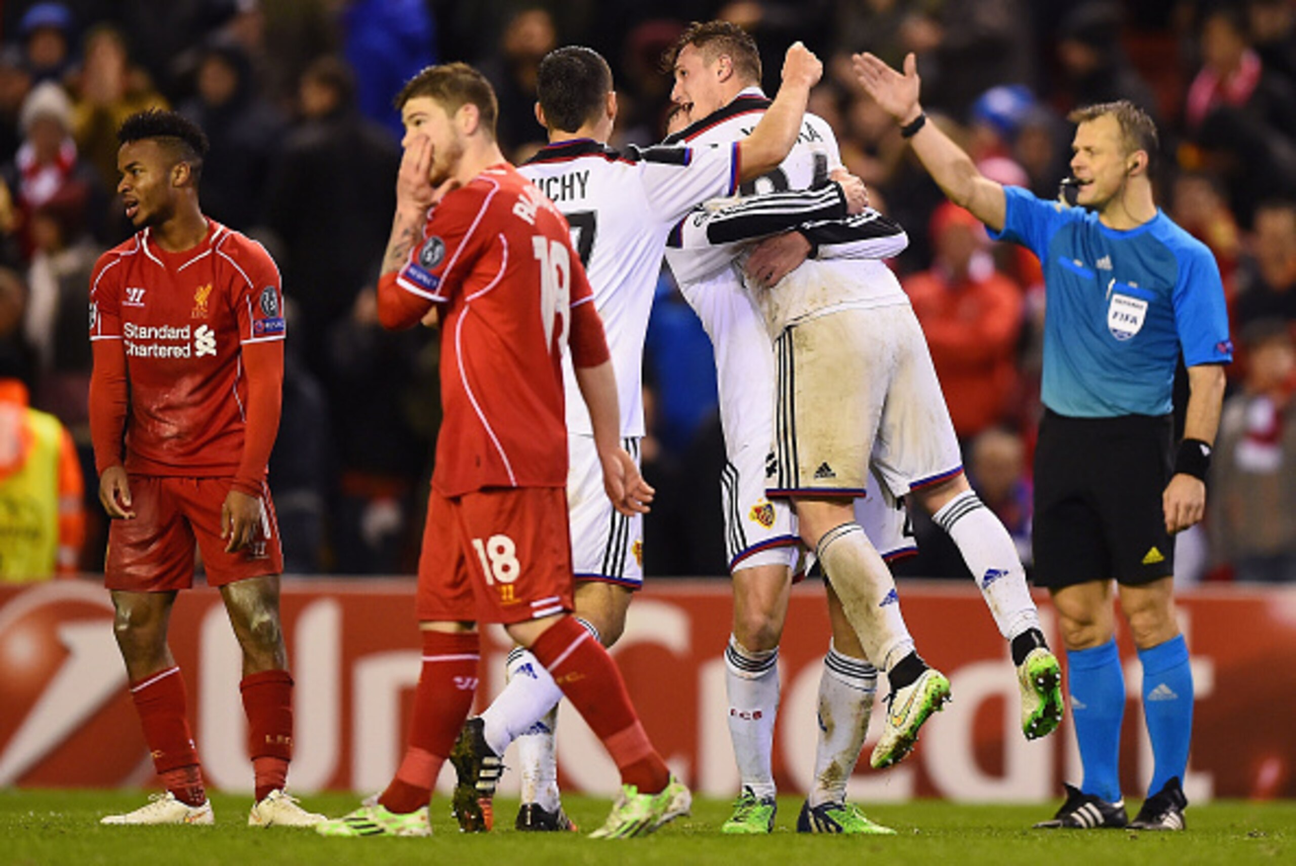 LIVERPOOL, ENGLAND - DECEMBER 09:  Basel players celebrate their team's 1-1 draw as the final whistle blows during the UEFA Champions League group B match between Liverpool and FC Basel 1893 at Anfield on December 9, 2014 in Liverpool, United Kingdom.  (P