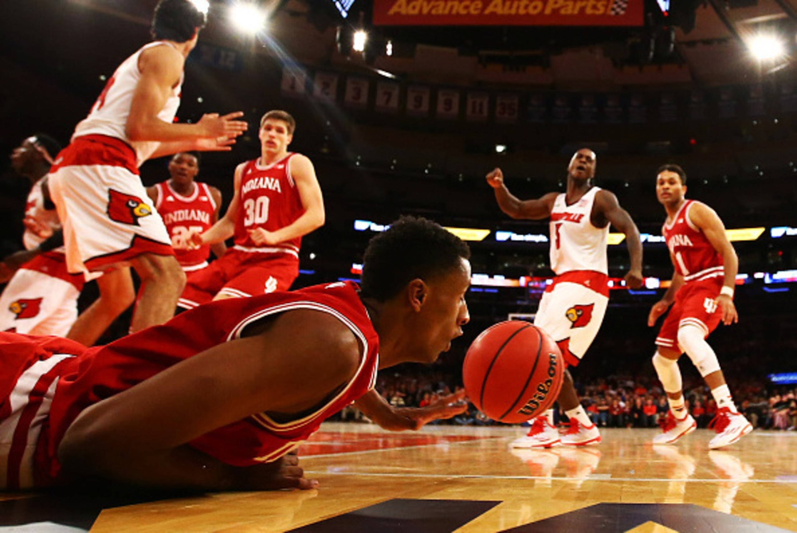 NEW YORK, NY - DECEMBER 09:  Troy Williams #5 of the Indiana Hoosiers falls chasing the ball against the Louisville Cardinals during their game at the Jimmy V Classic in Madison Square Garden on December 9, 2014 in New York City.  (Photo by Al Bello/Getty