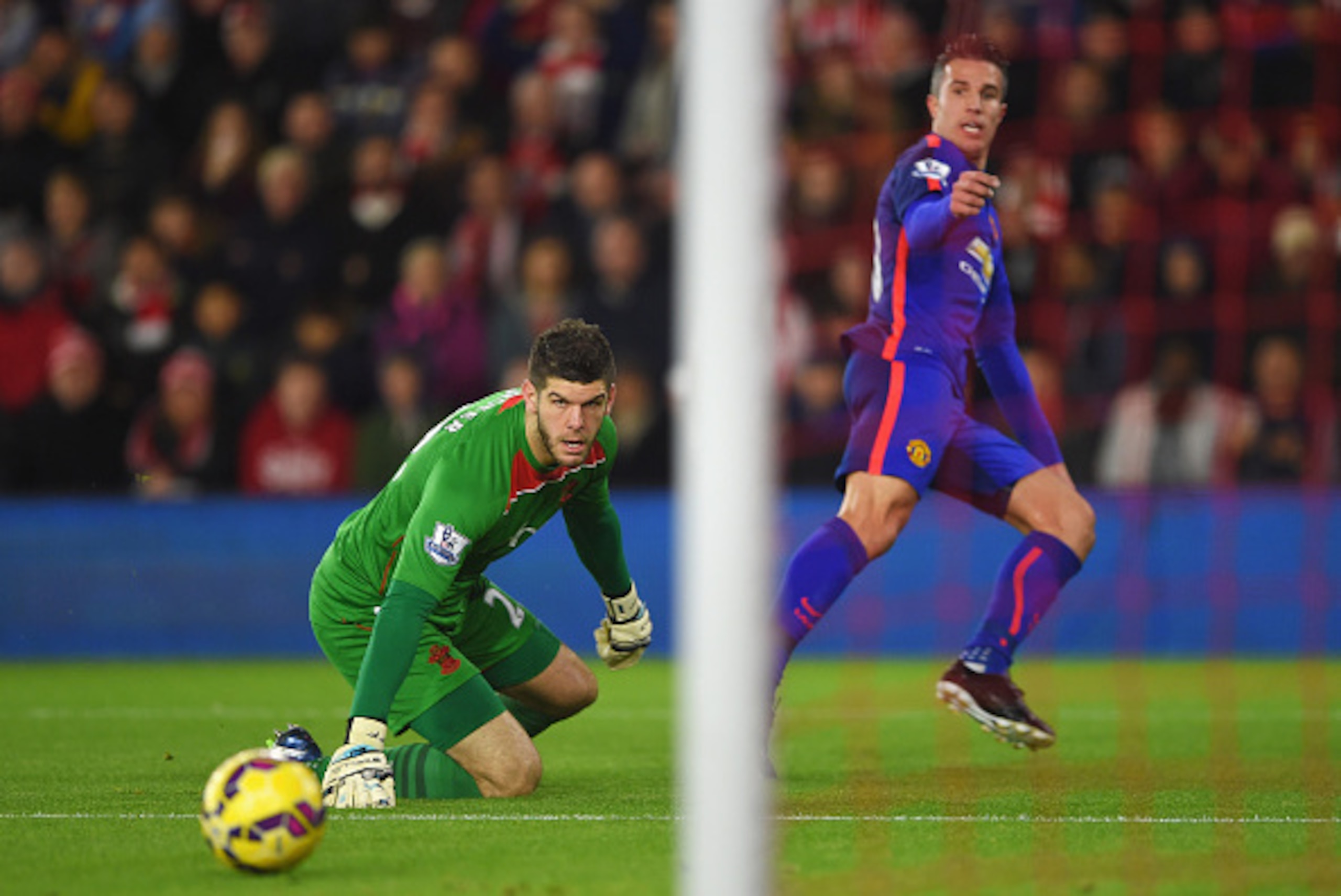 SOUTHAMPTON, ENGLAND - DECEMBER 08: Robin van Persie of Manchester United scores past Fraser Forster of Southampton for the opening goal during the Barclays Premier League match between Southampton and Manchester United at St Mary's Stadium on December 8 SOUTHAMPTON, ENGLAND - DECEMBER 08: Robin van Persie of Manchester United scores past Fraser Forster of Southampton for the opening goal during the Barclays Premier League match between Southampton and Manchester United at St Mary's Stadium on December 8
