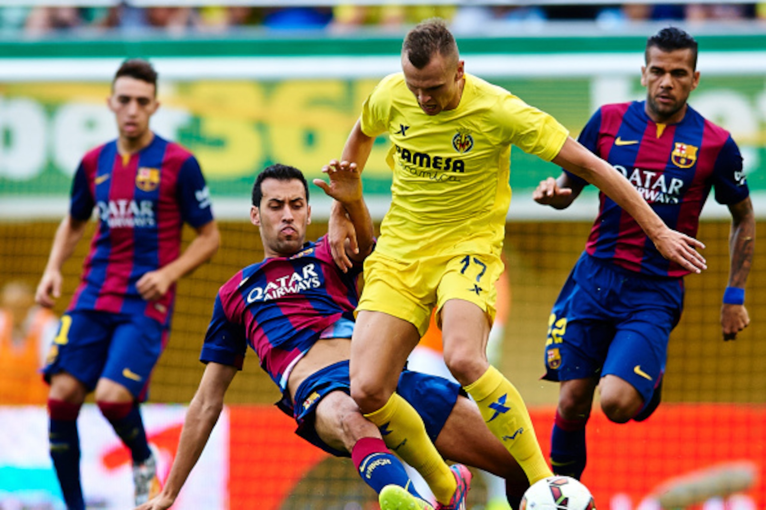 VILLARREAL, SPAIN - AUGUST 31:  Denis Cheryshev of Villarreal is tackled by Sergio Busquets of Barcelona during the La Liga match between Villarreal CF and FC Barcelona at El Madrigal stadium on August 31, 2014 in Villarreal, Spain.  (Photo by Manuel Quei