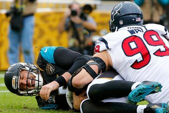 JACKSONVILLE, FL - DECEMBER 07:  Blake Bortles #5 of the Jacksonville Jaguars is sacked by  J.J. Watt #99 of the Houston Texans during the game at EverBank Field on December 7, 2014 in Jacksonville, Florida.  (Photo by Sam Greenwood/Getty Images)
