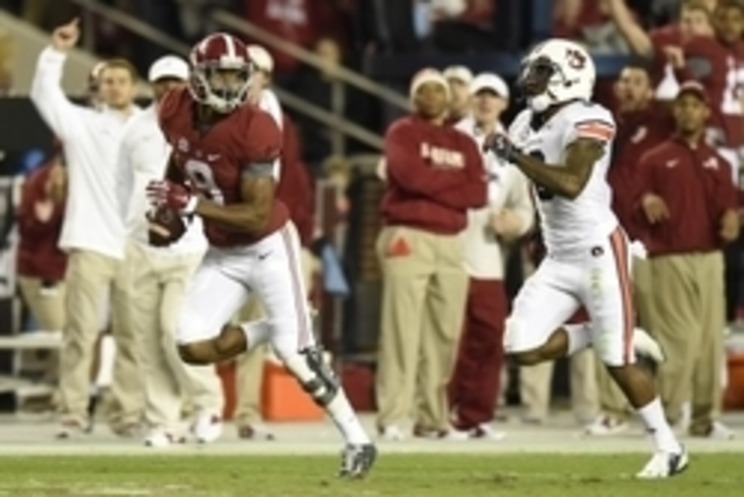 Nov 29, 2014; Tuscaloosa, AL, USA; Alabama Crimson Tide wide receiver Amari Cooper (9) catches a touchdown pass in the third quarter  past Auburn Tigers defensive back Jonathon Mincy (6) at Bryant-Denny Stadium. Mandatory Credit: John David Mercer-USA TOD