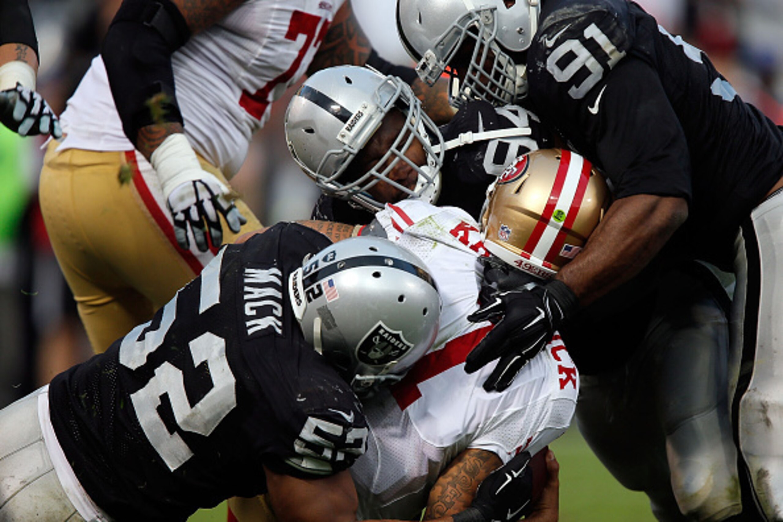 OAKLAND, CA - DECEMBER 07:  Justin Tuck #91 of the Oakland Raiders, Antonio Smith #94 of the Oakland Raiders, Khalil Mack #52 of the Oakland Raiders sack Colin Kaepernick #7 of the San Francisco 49ers in the fourth quarter at O.co Coliseum on December 7, 