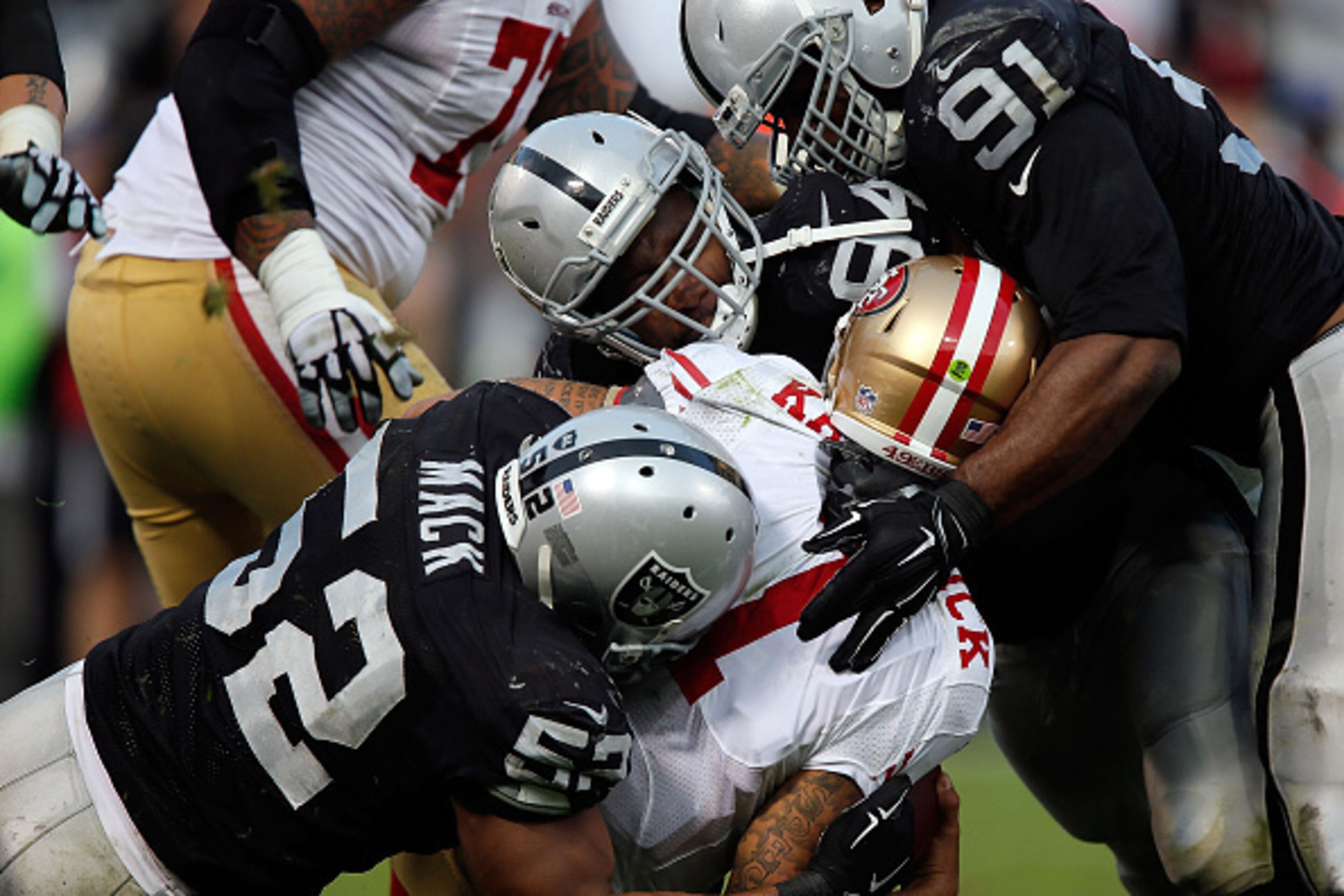 OAKLAND, CA - DECEMBER 07: Justin Tuck #91 of the Oakland Raiders, Antonio Smith #94 of the Oakland Raiders, Khalil Mack #52 of the Oakland Raiders sack Colin Kaepernick #7 of the San Francisco 49ers in the fourth quarter at O.co Coliseum on December 7, OAKLAND, CA - DECEMBER 07: Justin Tuck #91 of the Oakland Raiders, Antonio Smith #94 of the Oakland Raiders, Khalil Mack #52 of the Oakland Raiders sack Colin Kaepernick #7 of the San Francisco 49ers in the fourth quarter at O.co Coliseum on December 7,
