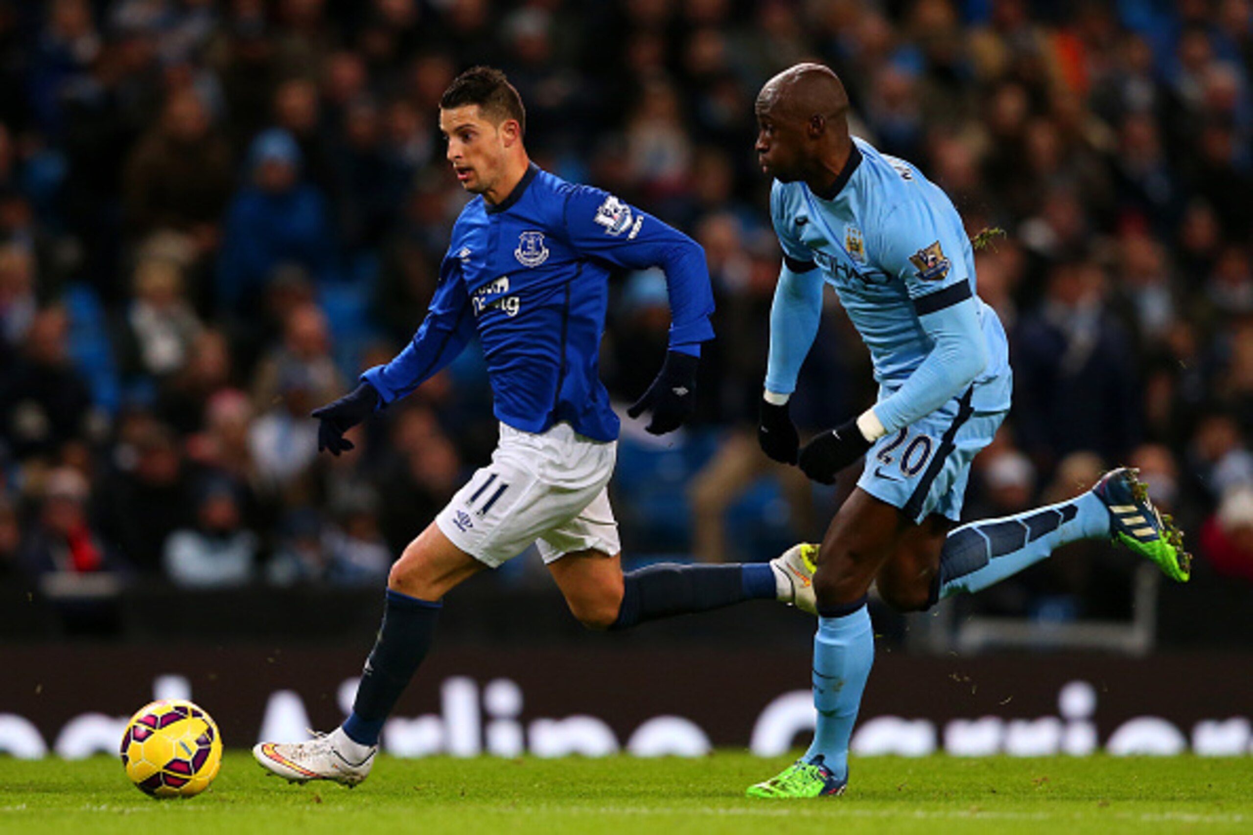 MANCHESTER, ENGLAND - DECEMBER 06:  Kevin Mirallas of Everton runs with the ball past Eliaquim Mangala of Manchester City during the Barclays Premier League match between Manchester City and Everton at Etihad Stadium on December 6, 2014 in Manchester, Eng