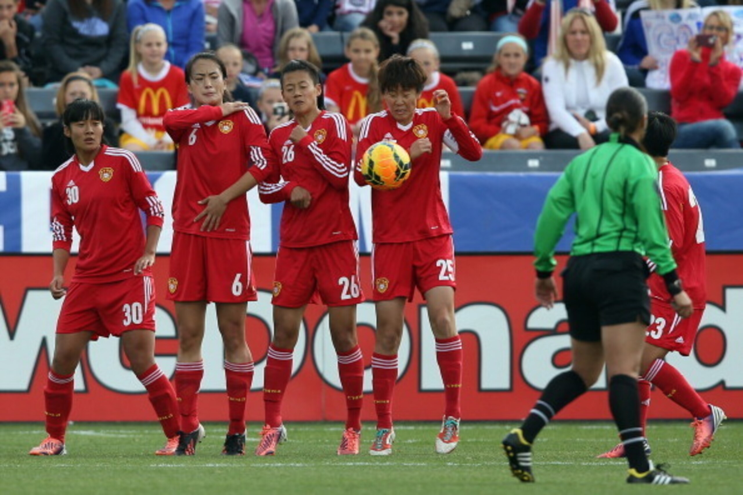 COMMERCE CITY, CO - APRIL 06:  Liu Shanshan #30, Zeng Ying #6, Li Dongna #26 and Zhang Xin #25 of China defend against a free kick by the United States at Dick's Sporting Goods Park on April 6, 2014 in Commerce City, Colorado. The United States defeated C