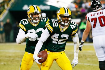 GREEN BAY, WI - DECEMBER 08:  Morgan Burnett #42 celebrates his interception with  Micah Hyde #33 of the Green Bay Packers in the second quarter against the Atlanta Falcons at Lambeau Field on December 8, 2014 in Green Bay, Wisconsin.  (Photo by Kevin C. 