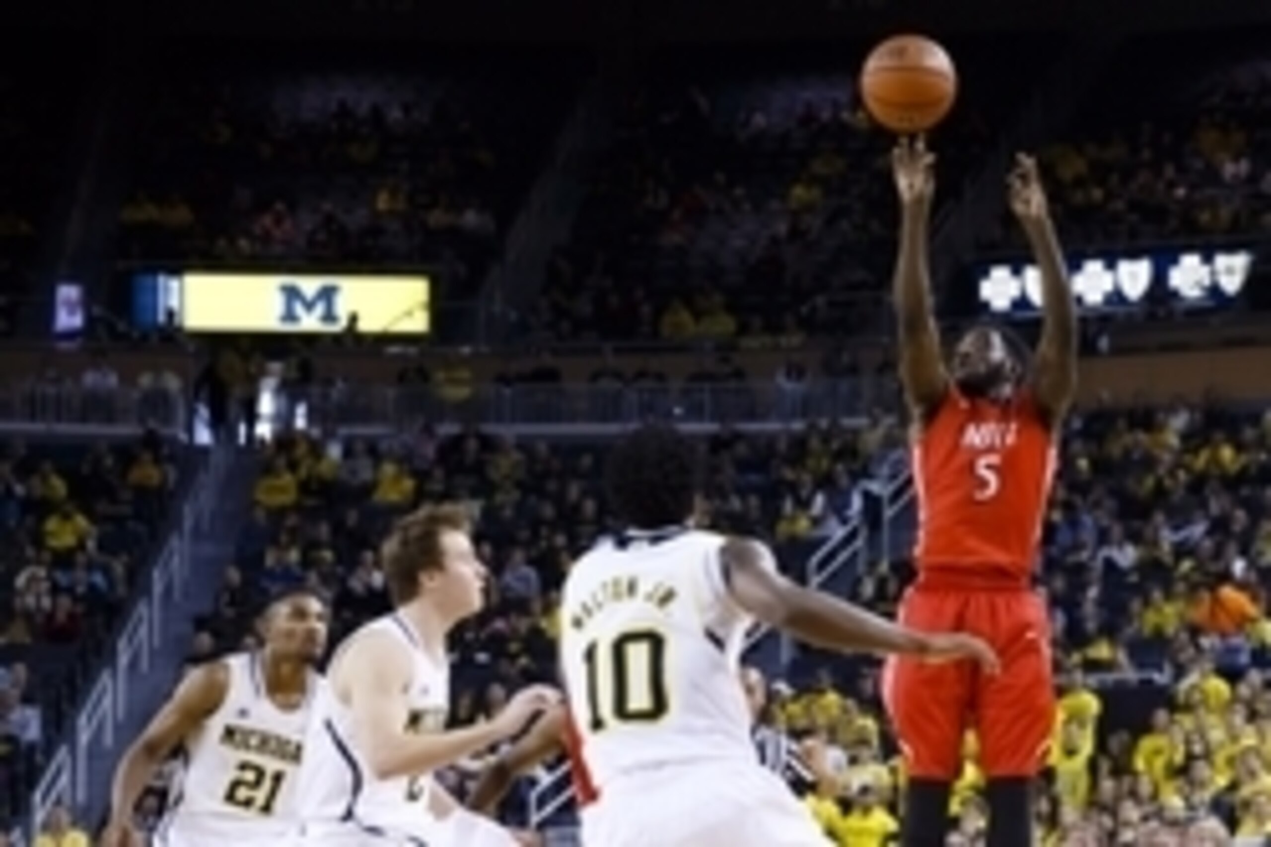 Dec 6, 2014; Ann Arbor, MI, USA; N.J.I.T Highlanders guard Damon Lynn (5) shoots over Michigan Wolverines guard Derrick Walton Jr. (10) guard Spike Albrecht (2) and guard/forward Zak Irvin (21) in the second half at Crisler Center. N.J.I.T won 72-70. Mand