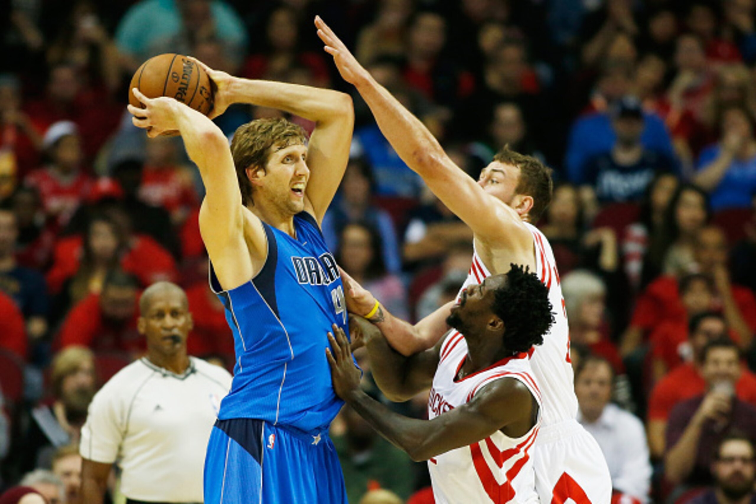 HOUSTON, TX - NOVEMBER 22:  Patrick Beverley #2 and Donatas Motiejunas #20 of the Houston Rockets defend against Dirk Nowitzki #41 of the Dallas Mavericks during their game at the Toyota Center on November 22, 2014 in Houston, Texas.  NOTE TO USER: User e