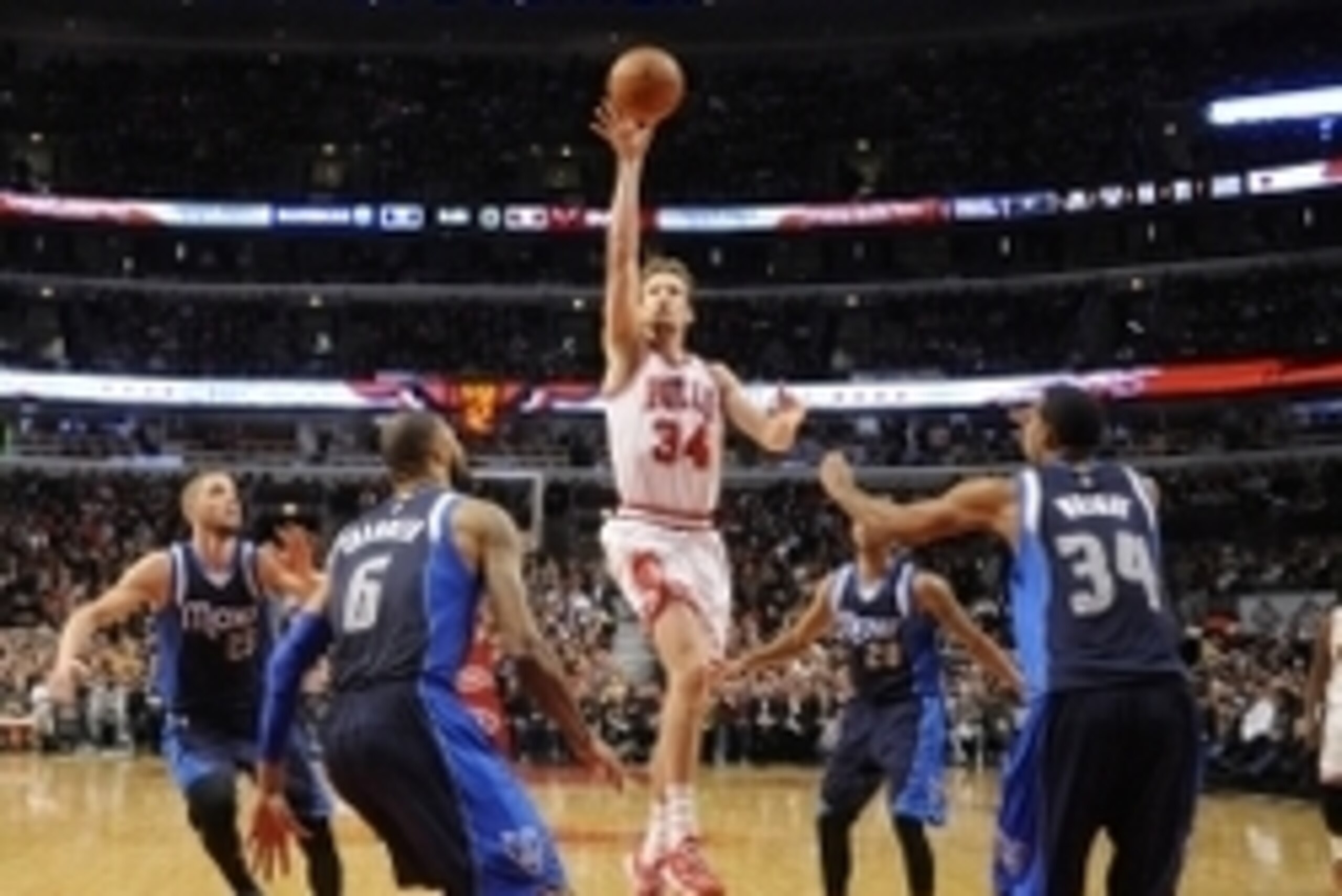 Dec 2, 2014; Chicago, IL, USA; Chicago Bulls forward Mike Dunleavy (34) shoots the ball in front of Dallas Mavericks center Tyson Chandler (6) and forward Brandan Wright (34) during the second half at the United Center. The Mavericks won 132- 129 in doubl