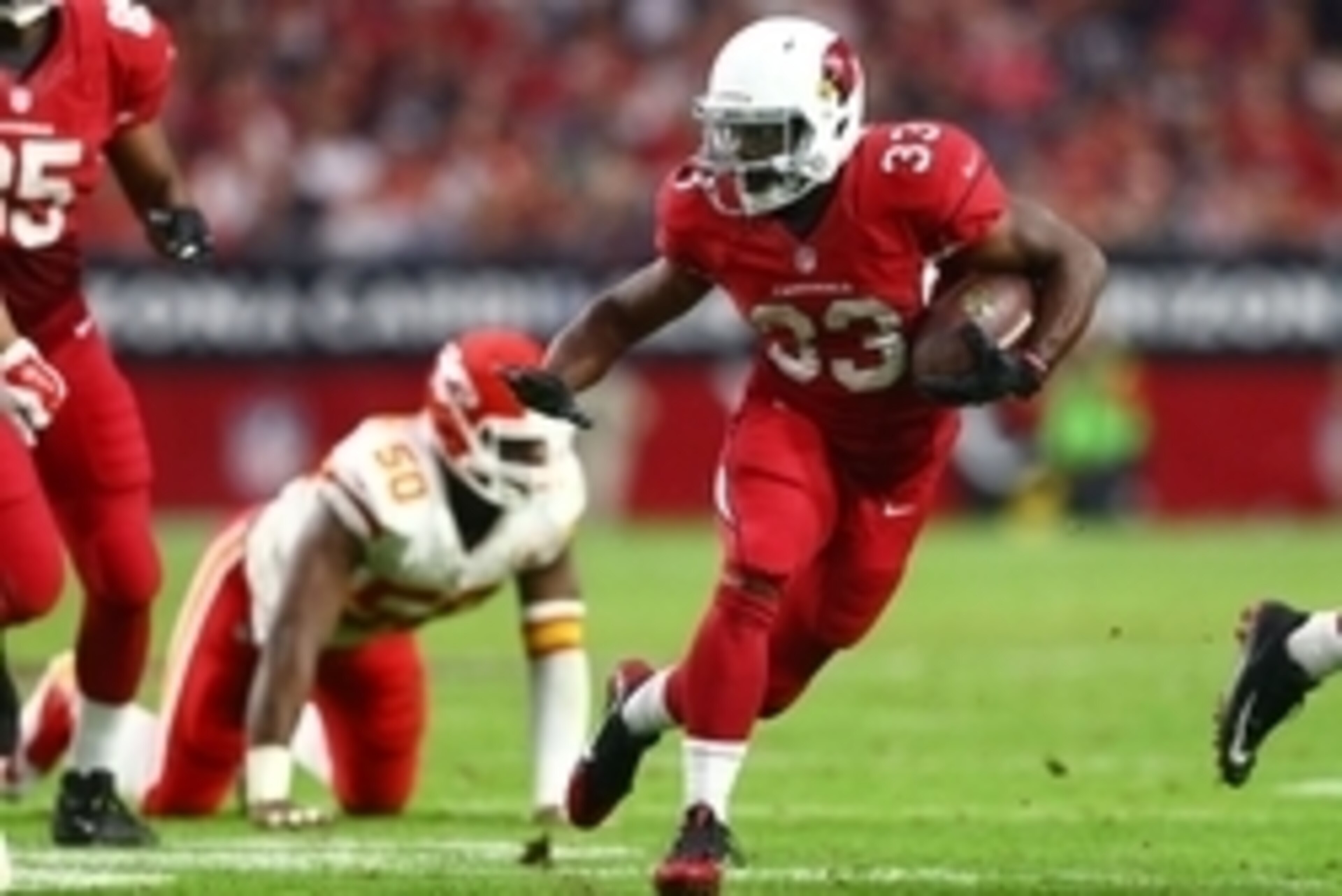 Dec 7, 2014; Glendale, AZ, USA; Arizona Cardinals running back Kerwynn Williams (33) runs the ball against the Kansas City Chiefs at University of Phoenix Stadium. The Cardinals defeated the Chiefs 17-14. Mandatory Credit: Mark J. Rebilas-USA TODAY Sports