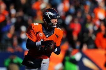 DENVER, CO - JANUARY 12:  Peyton Manning #18 of the Denver Broncos looks to pass against the San Diego Chargers during the AFC Divisional Playoff Game at Sports Authority Field at Mile High on January 12, 2014 in Denver, Colorado.  (Photo by Justin Edmond