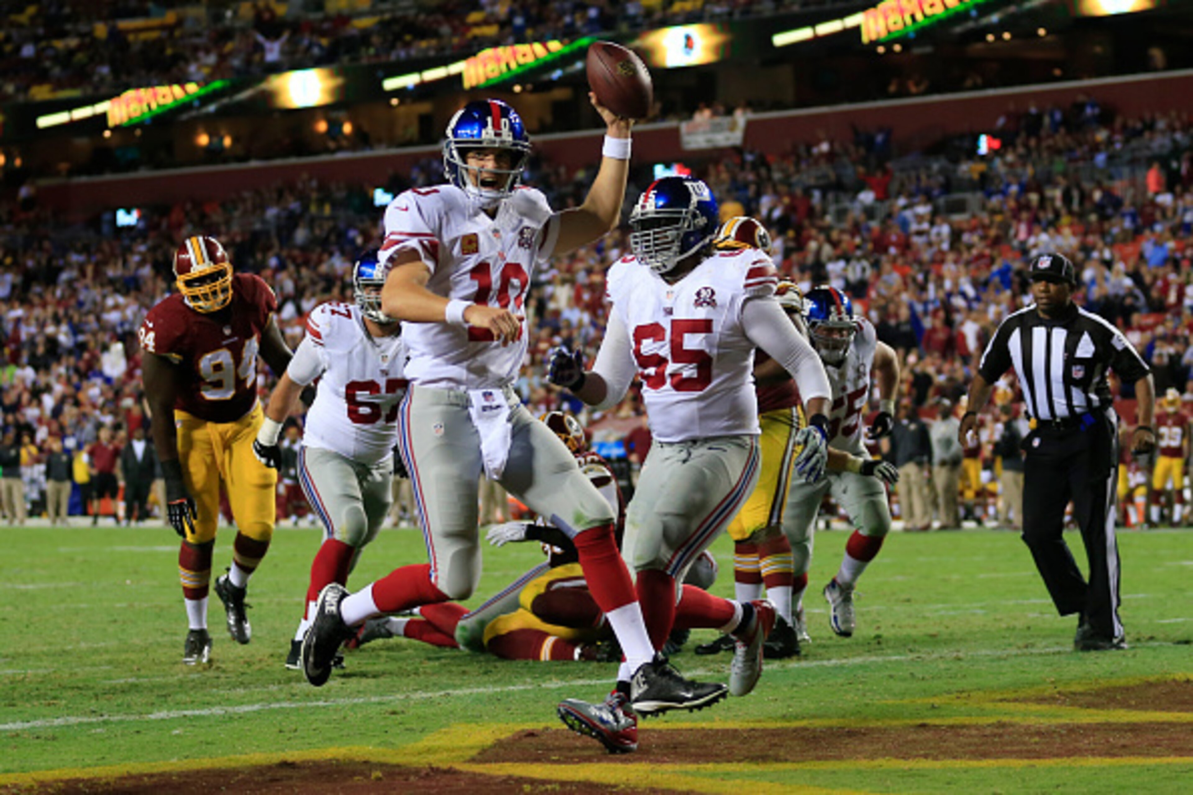 LANDOVER, MD - SEPTEMBER 25: Quarterback Eli Manning #10 of the New York Giants scores a fourth quarter touchdown against the Washington Redskins at FedExField on September 25, 2014 in Landover, Maryland. (Photo by Rob Carr/Getty Images)