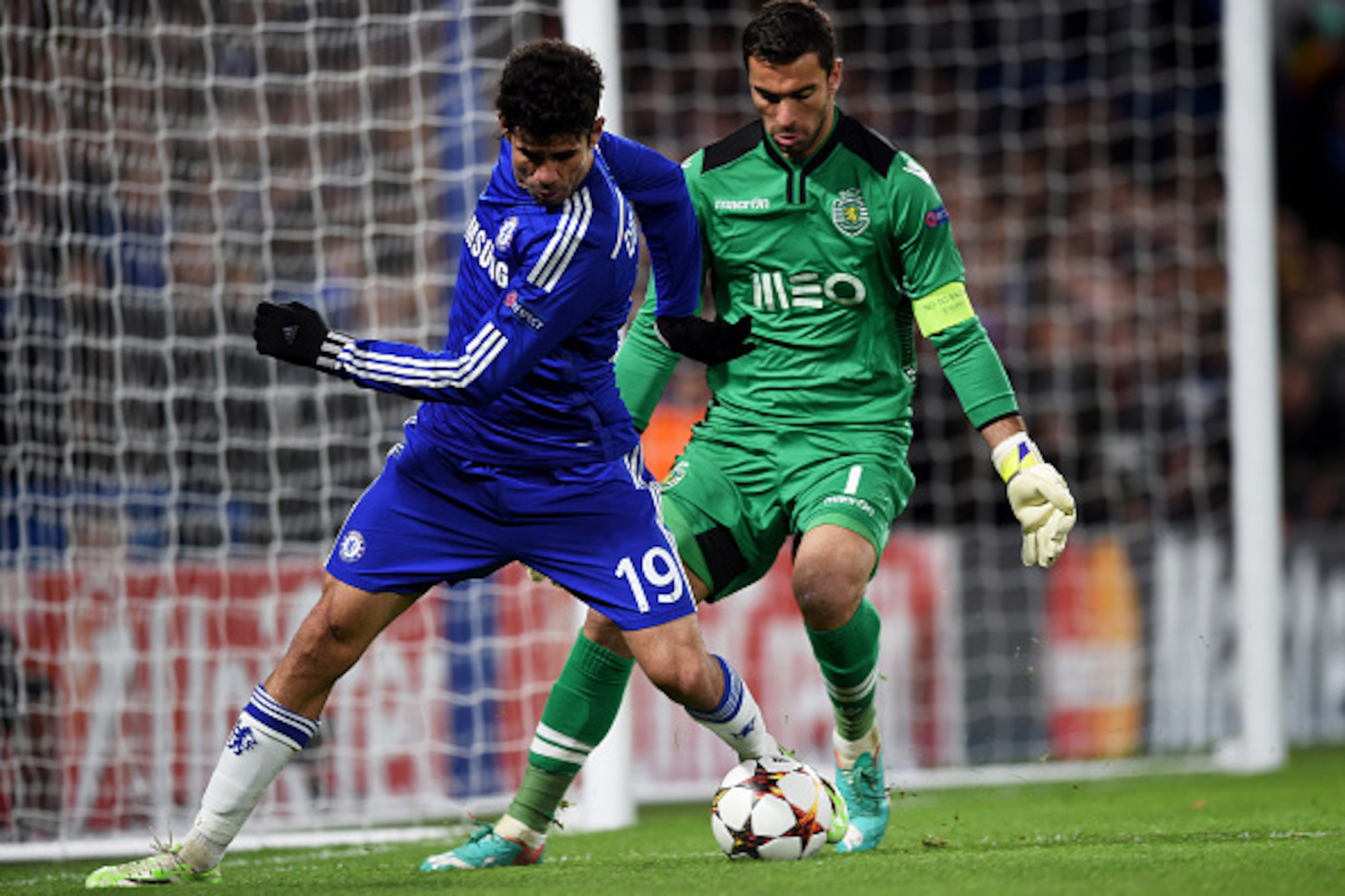 LONDON, ENGLAND - DECEMBER 10:  Diego Costa of Chelsea is challenged by goalkeeper Rui Patrcio of Sporting Lisbon during the UEFA Champions League group G match between Chelsea and Sporting Clube de Portugal at Stamford Bridge on December 10, 2014 in Lond