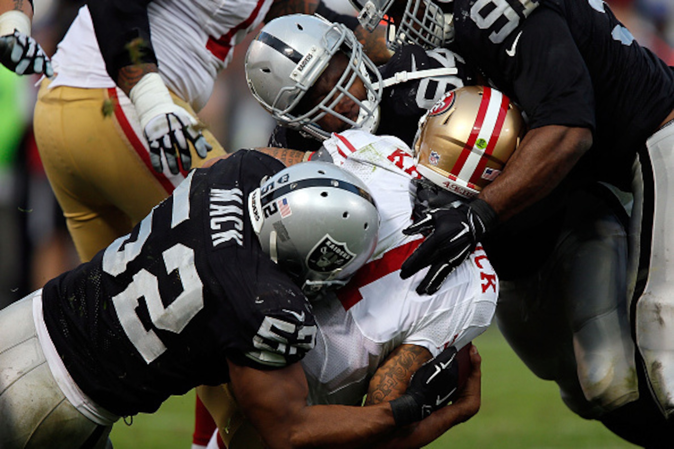 OAKLAND, CA - DECEMBER 07:  Justin Tuck #91 of the Oakland Raiders, Antonio Smith #94 of the Oakland Raiders, Khalil Mack #52 of the Oakland Raiders sack Colin Kaepernick #7 of the San Francisco 49ers in the fourth quarter at O.co Coliseum on December 7, 
