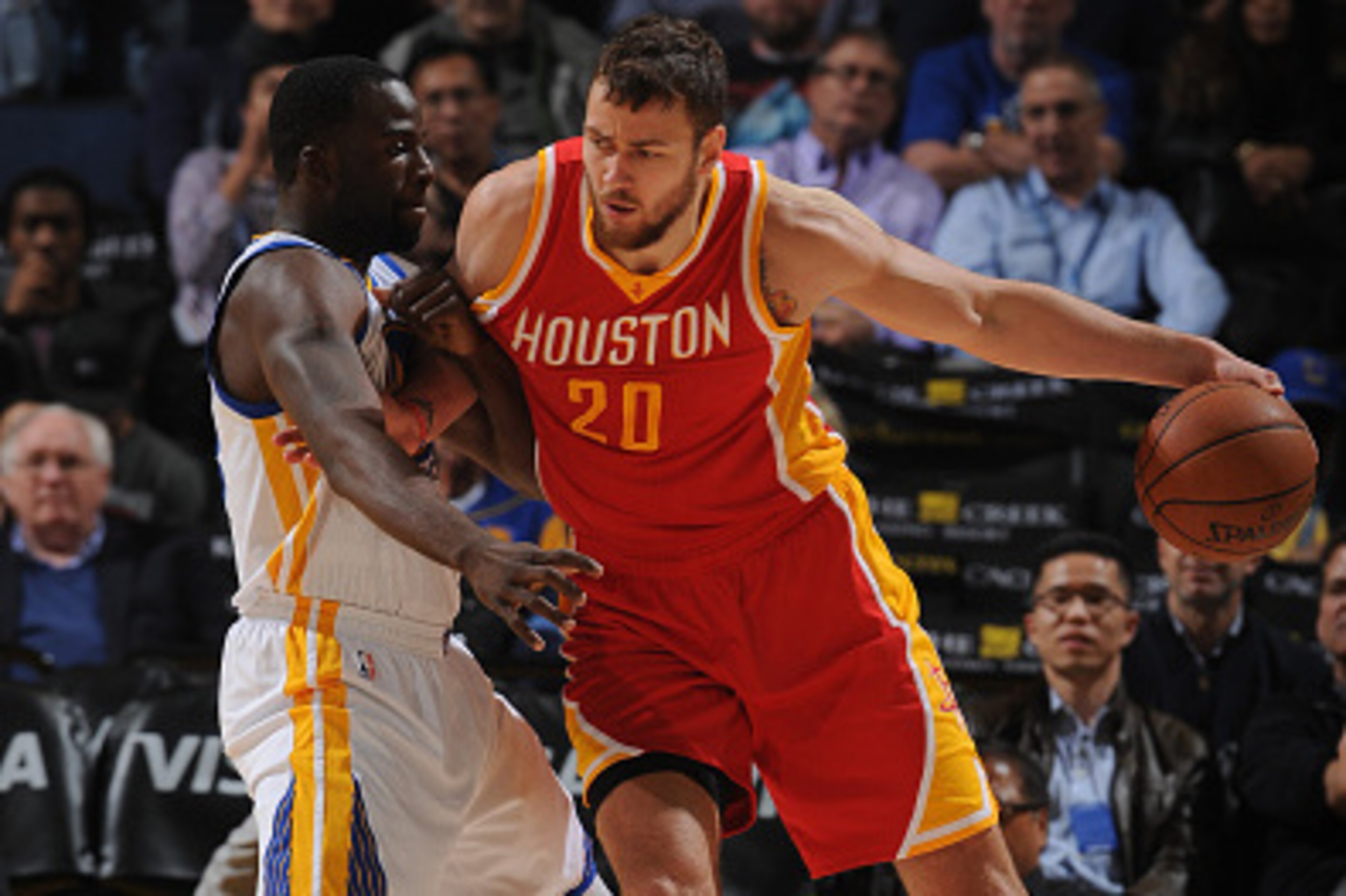 OAKLAND, CA - DECEMBER 10: Donatas Motiejunas #20 of the Houston Rockets posts up against Draymond Green #23 of the Golden State Warriors on December 10, 2014 at Oracle Arena in Oakland, California. NOTE TO USER: User expressly acknowledges and agrees tha