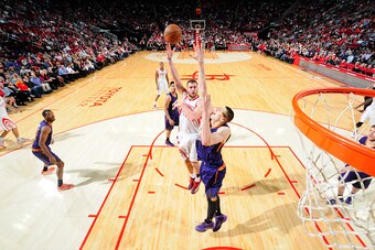 HOUSTON, TX -  DECEMBER 6: Donatas Motiejunas #20 of the Houston Rockets goes up for a shot against the Phoenix Suns on December 6, 2014 at Toyota Center in Houston, Texas. NOTE TO USER: User expressly acknowledges and agrees that, by downloading and or u