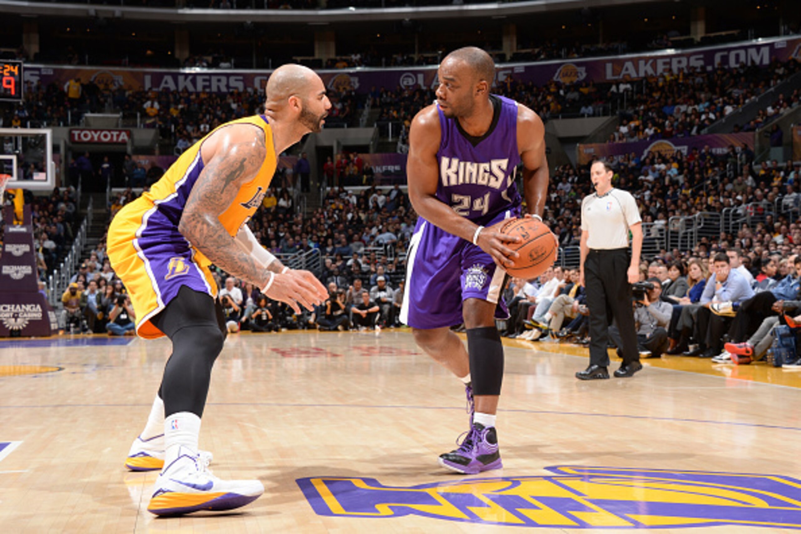 LOS ANGELES, CA - DECEMBER 9: Carl Landry #24 of the Sacramento Kings handles the ball against Carlos Boozer #5 of the Los Angeles Lakers on December 9, 2014 at STAPLES Center in Los Angeles, California. NOTE TO USER: User expressly acknowledges and agree