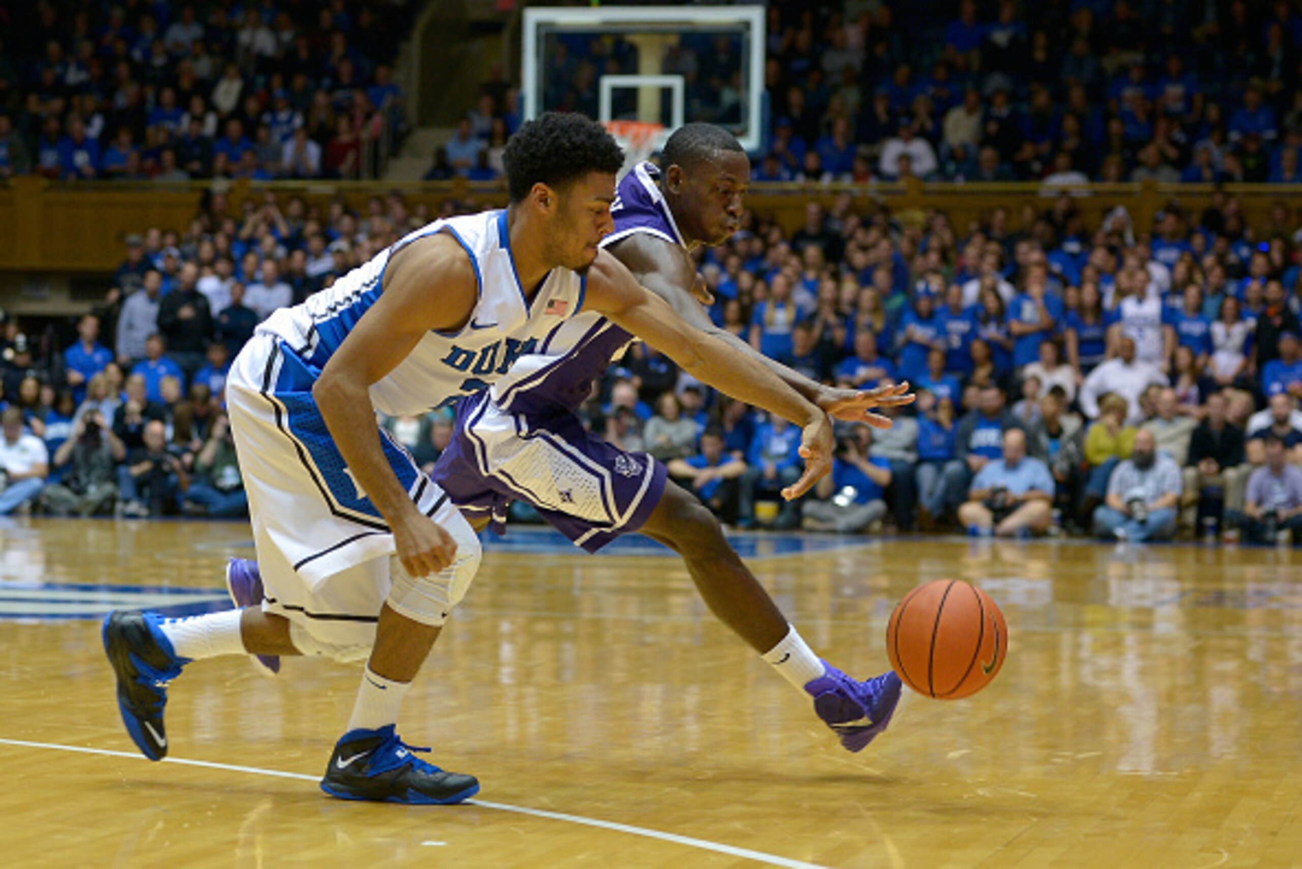 DURHAM, NC - NOVEMBER 26: Quinn Cook #2 of the Duke Blue Devils battles for a loose ball with Larry Wideman #24 of the Furman Paladins during their game at Cameron Indoor Stadium on November 26, 2014 in Durham, North Carolina. Duke won 93-54. (Photo by Gr