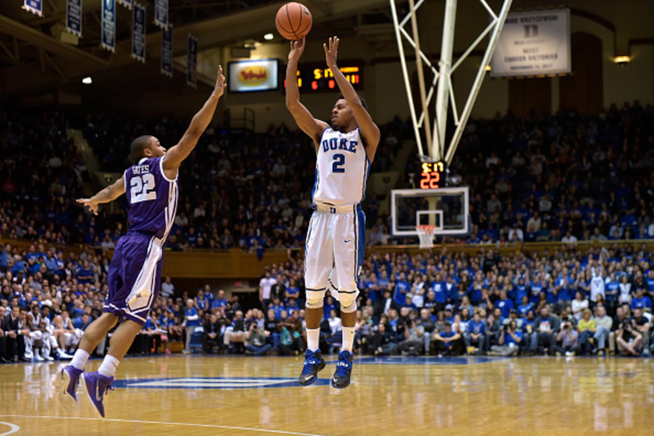 DURHAM, NC - NOVEMBER 26: Quinn Cook #2 of the Duke Blue Devils shoots over defender William Gates Jr. #22 of the Furman Paladins during their game at Cameron Indoor Stadium on November 26, 2014 in Durham, North Carolina. (Photo by Grant Halverson/Getty I