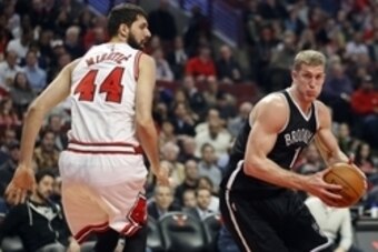 Dec 10, 2014; Chicago, IL, USA; Brooklyn Nets center Mason Plumlee (1) goes to the basket against Chicago Bulls forward Nikola Mirotic (44) during the first half of their NBA game at United Center. Mandatory Credit: Kamil Krzaczynski-USA TODAY Sports