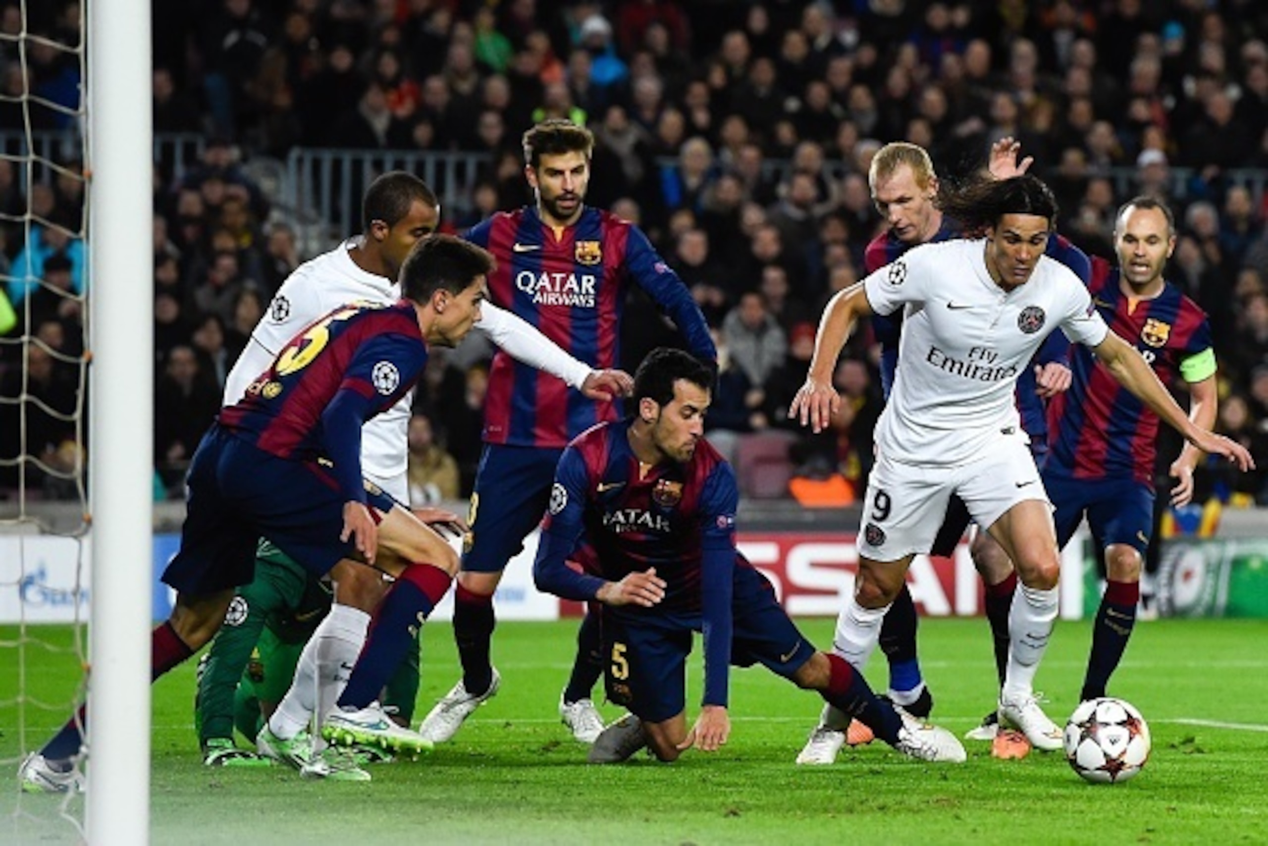 BARCELONA, SPAIN - DECEMBER 10:  Edinson Cavani of Paris Saint-Germain FC competes for the ball with FC Barcelona players during the UEFA Champions League group F match between FC Barcelona and Paris Saint-Germanin FC at Camp Nou Stadium on December 10, 2