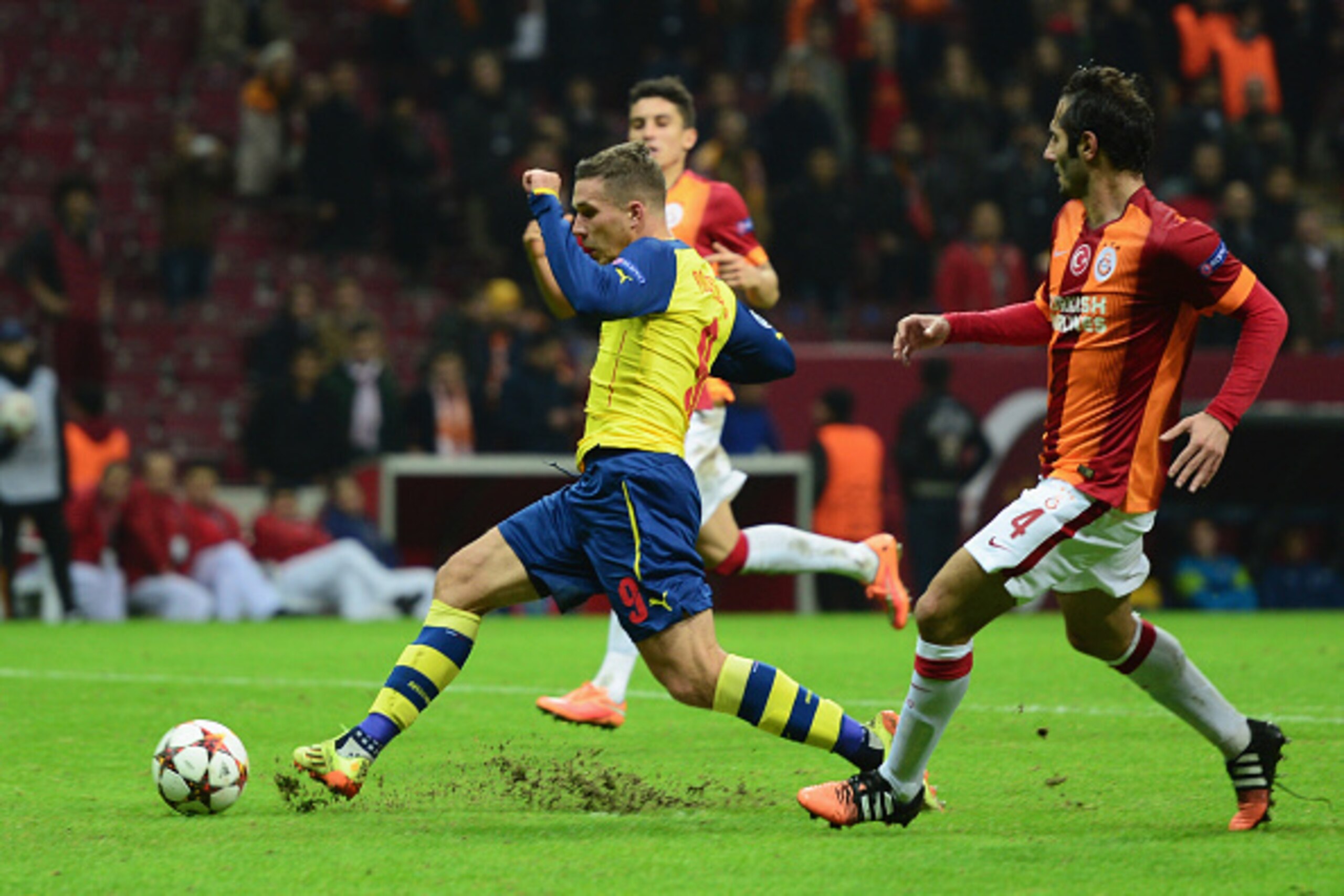 ISTANBUL, TURKEY - DECEMBER 09:  Lukas Podolski of Arsenal scores their fourth goal during the UEFA Champions League Group D match between Galatasaray AS and Arsenal FC at Ali Sami Yen Arena on December 9, 2014 in Istanbul, Turkey.  (Photo by Jamie McDona