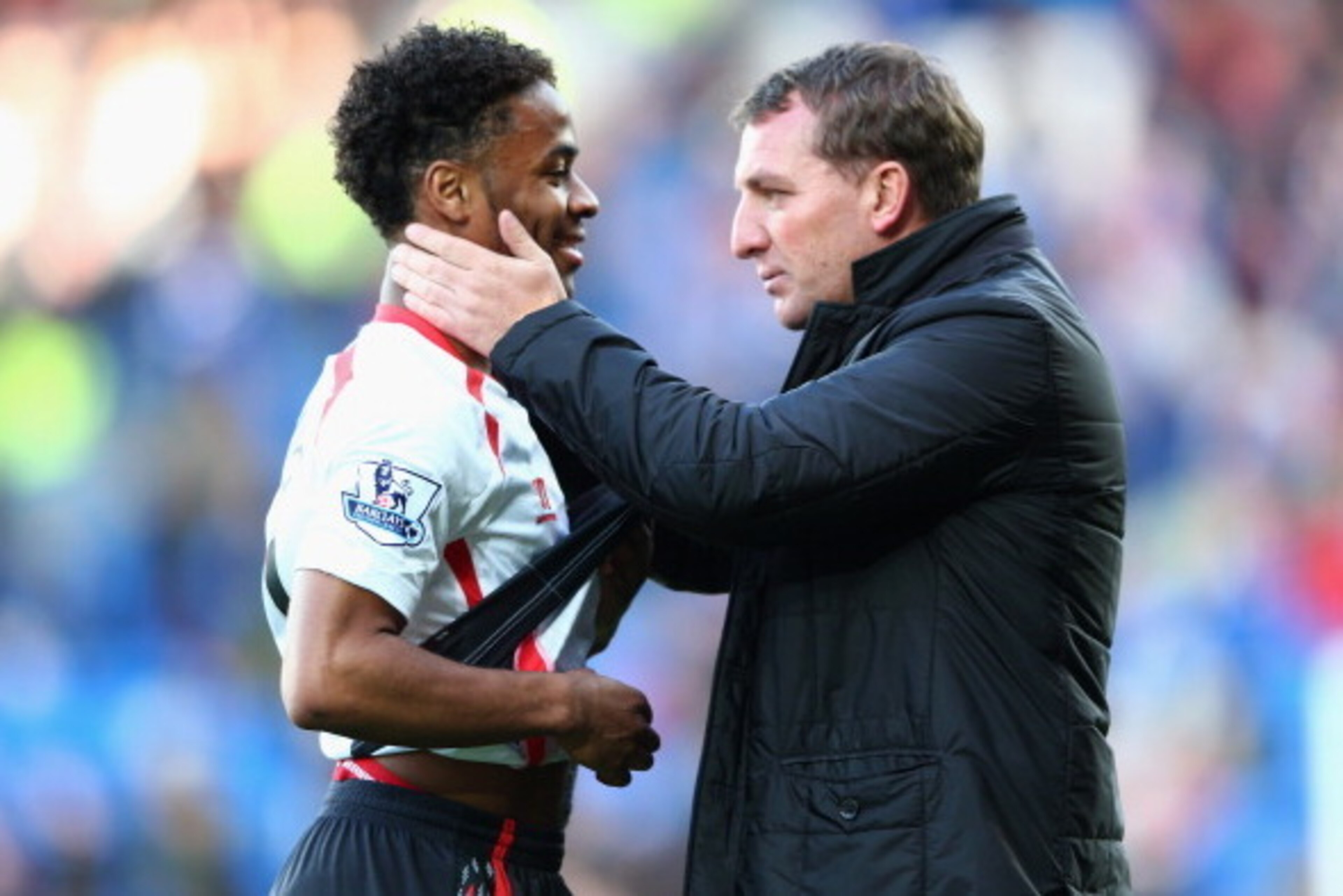 CARDIFF, WALES - MARCH 22:  Brendan Rodgers (R) the manager of Liverpool chats with Raheem Sterling after his side's 6-3 victory during the Barclays Premier League match between Cardiff City and Liverpool at the Cardiff City Stadium on March 22, 2014 in C
