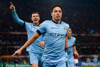 ROME, ITALY - DECEMBER 10:  Samir Nasri of Manchester City (front) celebrates with Edin Dzeko (L) as he scores their first goal during the UEFA Champions League Group E match between AS Roma and Manchester City FC at Stadio Olimpico on December 10, 2014 i
