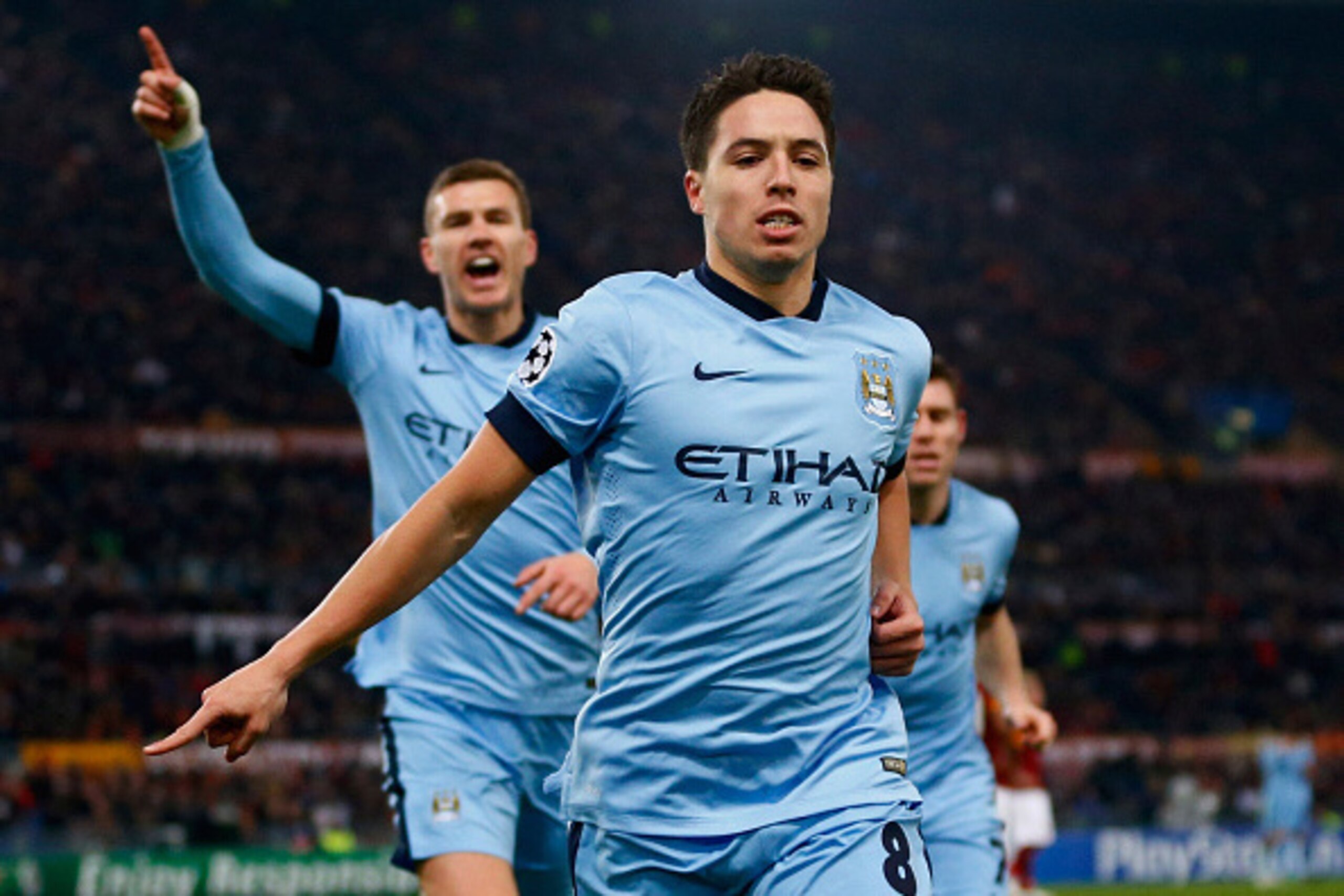ROME, ITALY - DECEMBER 10:  Samir Nasri of Manchester City (front) celebrates with Edin Dzeko (L) as he scores their first goal during the UEFA Champions League Group E match between AS Roma and Manchester City FC at Stadio Olimpico on December 10, 2014 i
