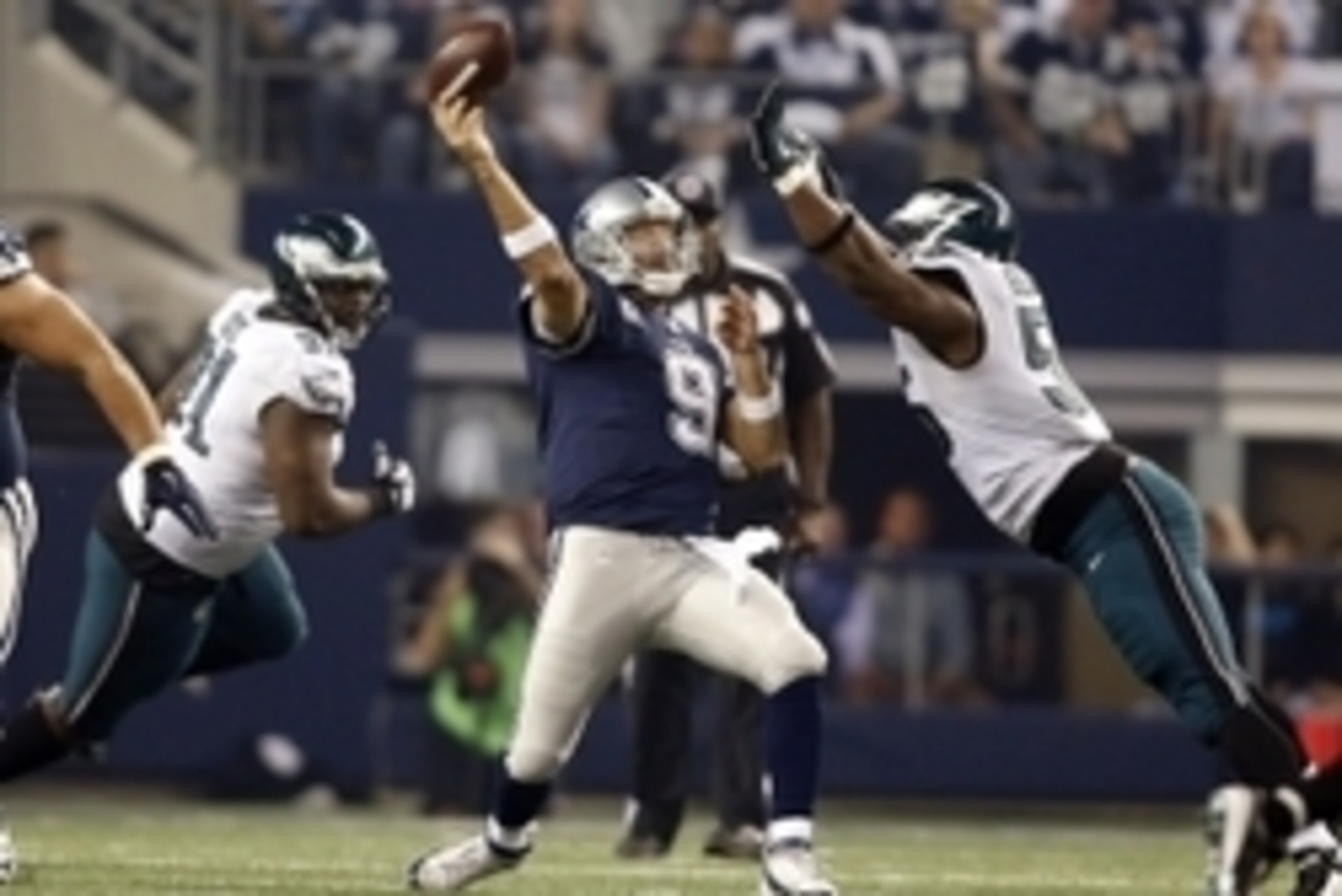 Nov 27, 2014; Arlington, TX, USA; Dallas Cowboys quarterback Tony Romo (9) throws while pressured by Philadelphia Eagles linebacker Brandon Graham (55) in the third quarter at AT&T Stadium. Mandatory Credit: Tim Heitman-USA TODAY Sports