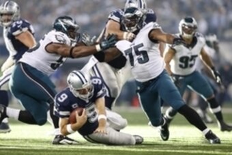 Nov 27, 2014; Arlington, TX, USA;  Dallas Cowboys quarterback Tony Romo (9) is sacked by Philadelphia Eagles defensive end Vinny Curry (75) and linebacker Brandon Graham (55) in the second quarter at AT&T Stadium. Mandatory Credit: Tim Heitman-USA TODAY S