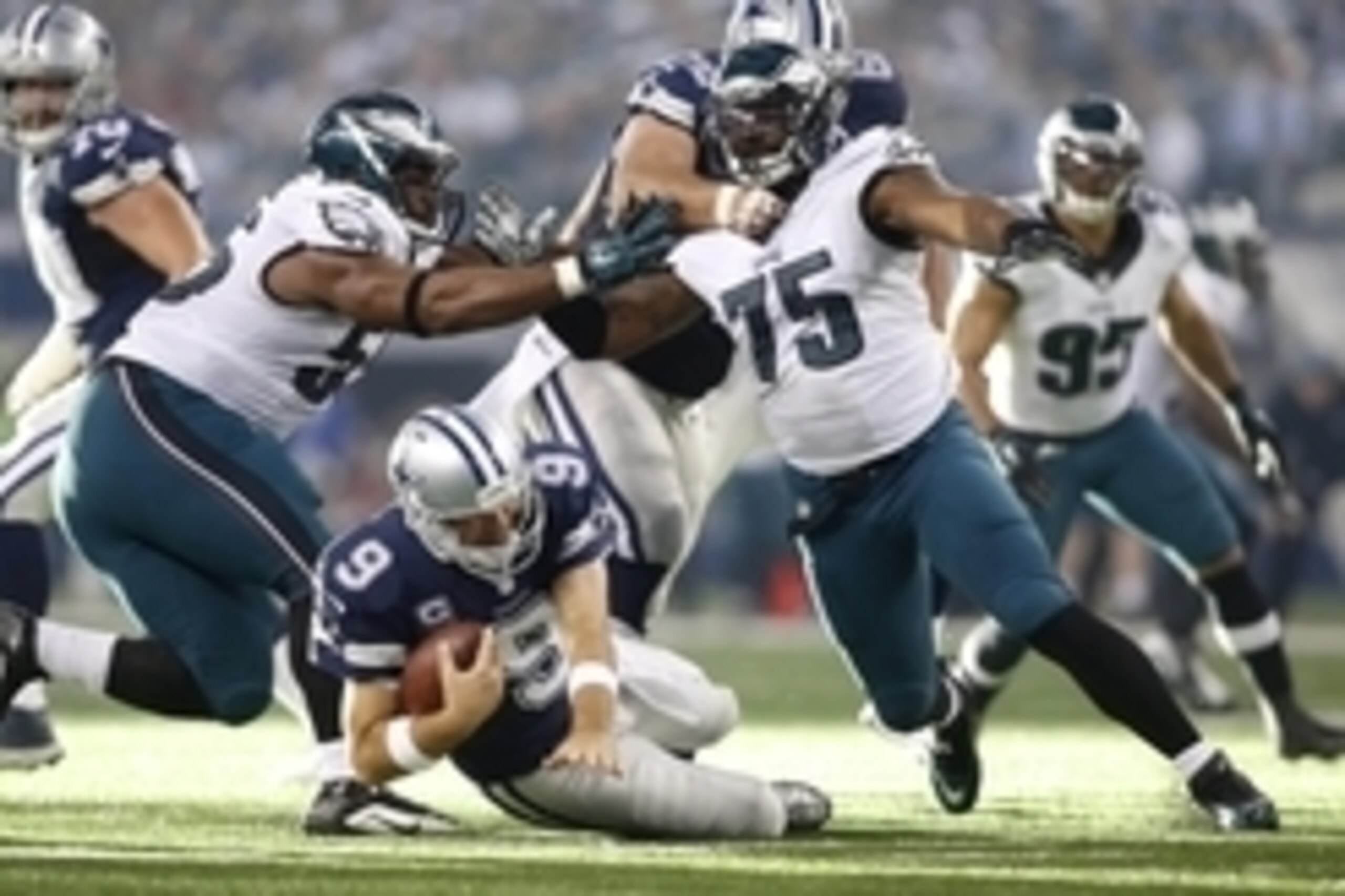 Nov 27, 2014; Arlington, TX, USA;  Dallas Cowboys quarterback Tony Romo (9) is sacked by Philadelphia Eagles defensive end Vinny Curry (75) and linebacker Brandon Graham (55) in the second quarter at AT&T Stadium. Mandatory Credit: Tim Heitman-USA TODAY S