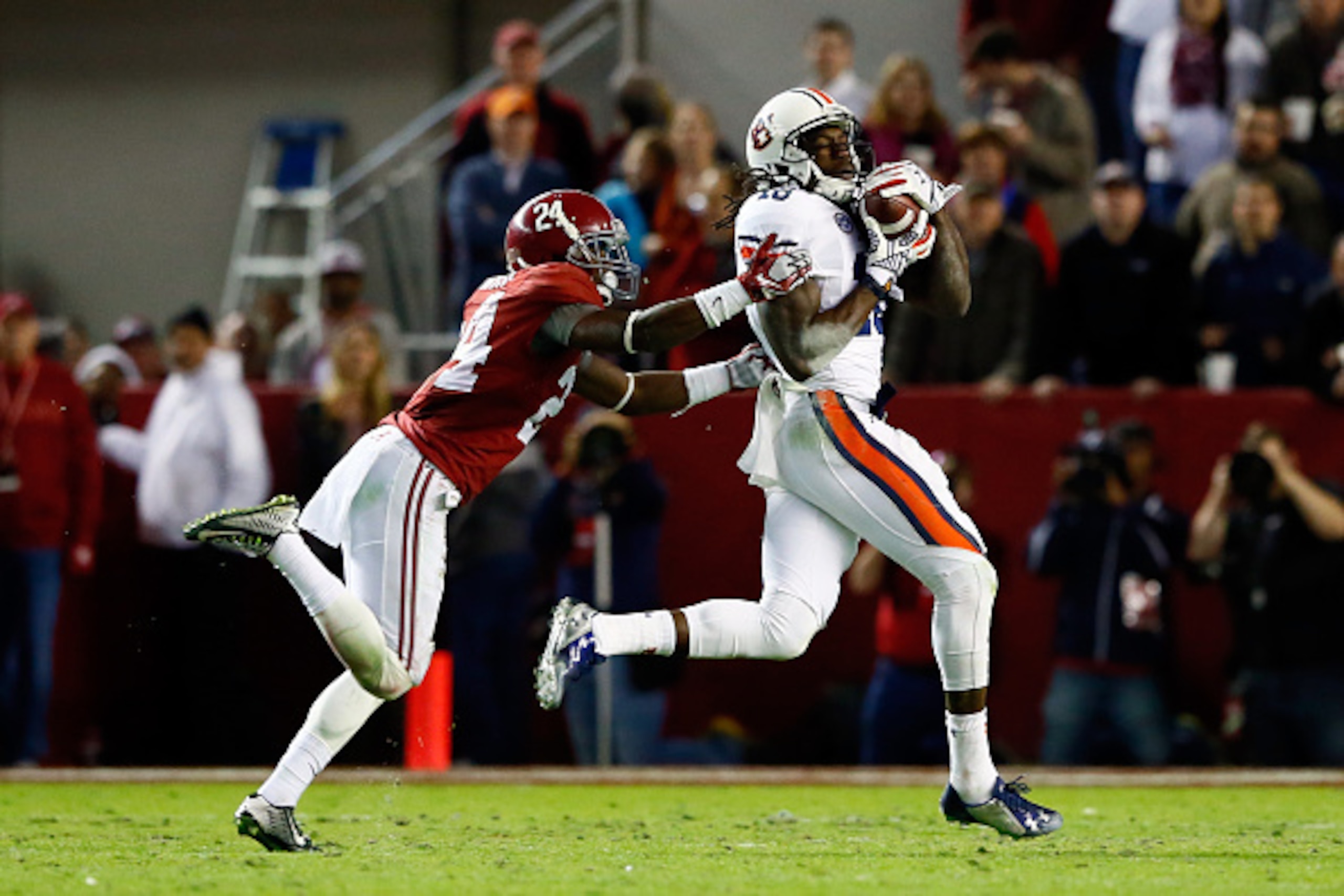 TUSCALOOSA, AL - NOVEMBER 29:  Sammie Coates #18 of the Auburn Tigers catches a 53 yard pass thrown by Nick Marshall #14 in the fourth quarter against Geno Smith #24 of the Alabama Crimson Tide during the Iron Bowl at Bryant-Denny Stadium on November 29, 