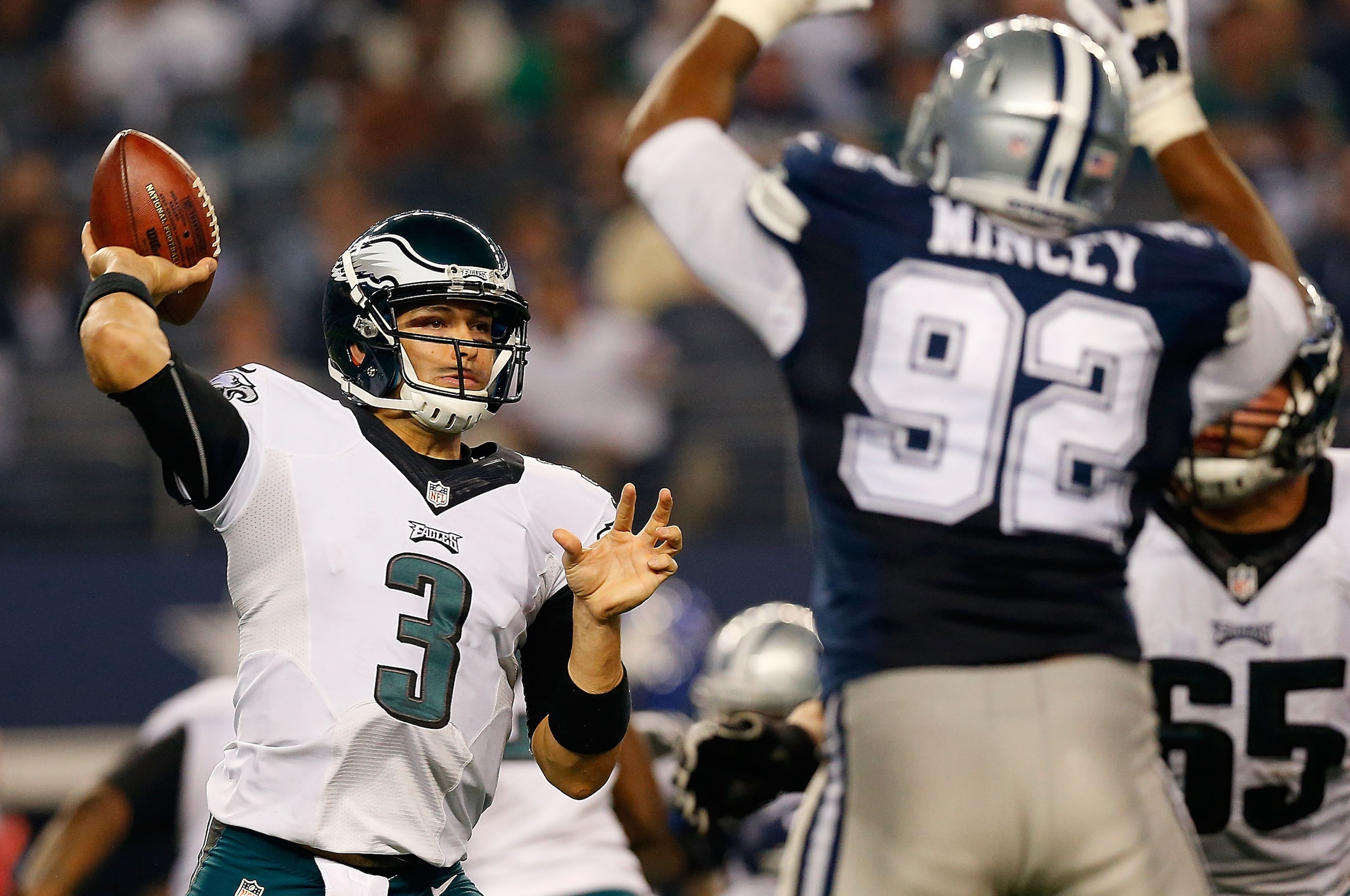 ARLINGTON, TX - NOVEMBER 27:  Mark Sanchez #3 of the Philadelphia Eagles passes as Jeremy Mincey #92 of the Dallas Cowboys applies pressure in the second half at AT&T Stadium on November 27, 2014 in Arlington, Texas.  (Photo by Tom Pennington/Getty Images