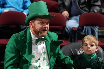 CLEVELAND - MARCH 17:  A man dressed as a leprechaun sits next to a young boy during the Cleveland Cavaliers game against the Portland Trail Blazers on March 17, 2006 at Quicken Loans Arena in Cleveland, Ohio. The Cavs won 99-84.  NOTE TO USER: User expre