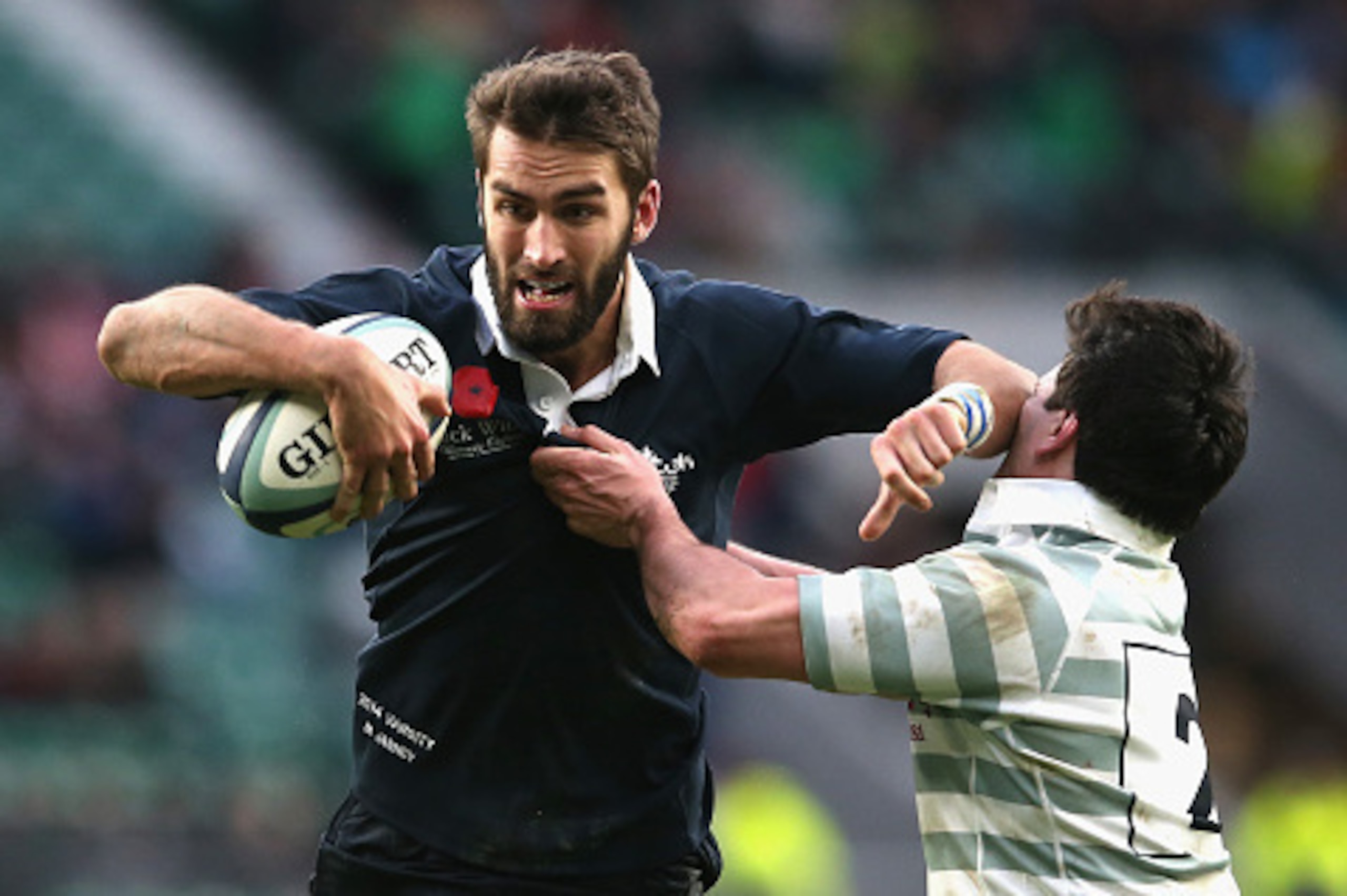 LONDON, ENGLAND - DECEMBER 11:  Matt Janney of Oxford  holds off Thomas Pascoe during the Varsity match between Oxford University and Cambridge University at Twickenham Stadium on December 11, 2014 in London, England.  (Photo by David Rogers/Getty Images)