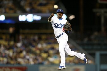 LOS ANGELES, CA - JUNE 17: Second baseman Dee Gordon #9 of the Los Angeles Dodgers throws to first to get Charlie Blackmon of the Colorado Rockies for the first out of the seventh inning at Dodger Stadium on June 17, 2014 in Los Angeles, California.  (Pho