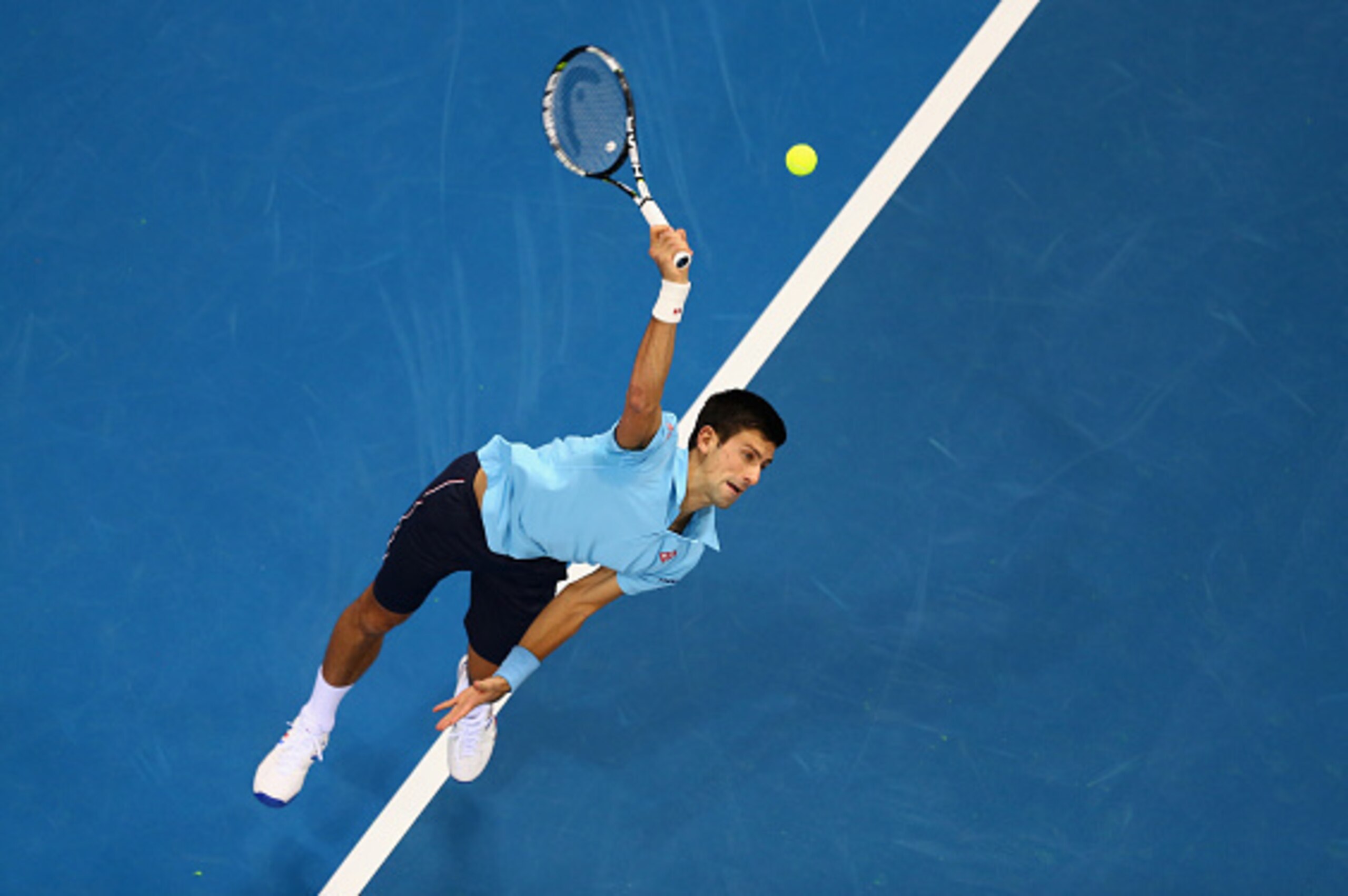 DUBAI, UNITED ARAB EMIRATES - DECEMBER 11: Novak Djokovic of the UAE Royals serves against Jo-Wi;lfried Tsonga of the Manila Mavericks during the Coca-Cola International Premier Tennis League fourth leg at the Hamdan Sports Complex, December 10, 2014 in D