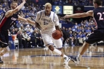 Dec 21, 2013; Lexington, KY, USA; Kentucky Wildcats forward Willie Cauley-Stein (15) dribbles the ball against Belmont Bruins forward Drew Windler (1) and guard Reece Chamberlain (22) in the first half at Rupp Arena. Mandatory Credit: Mark Zerof-USA TODAY