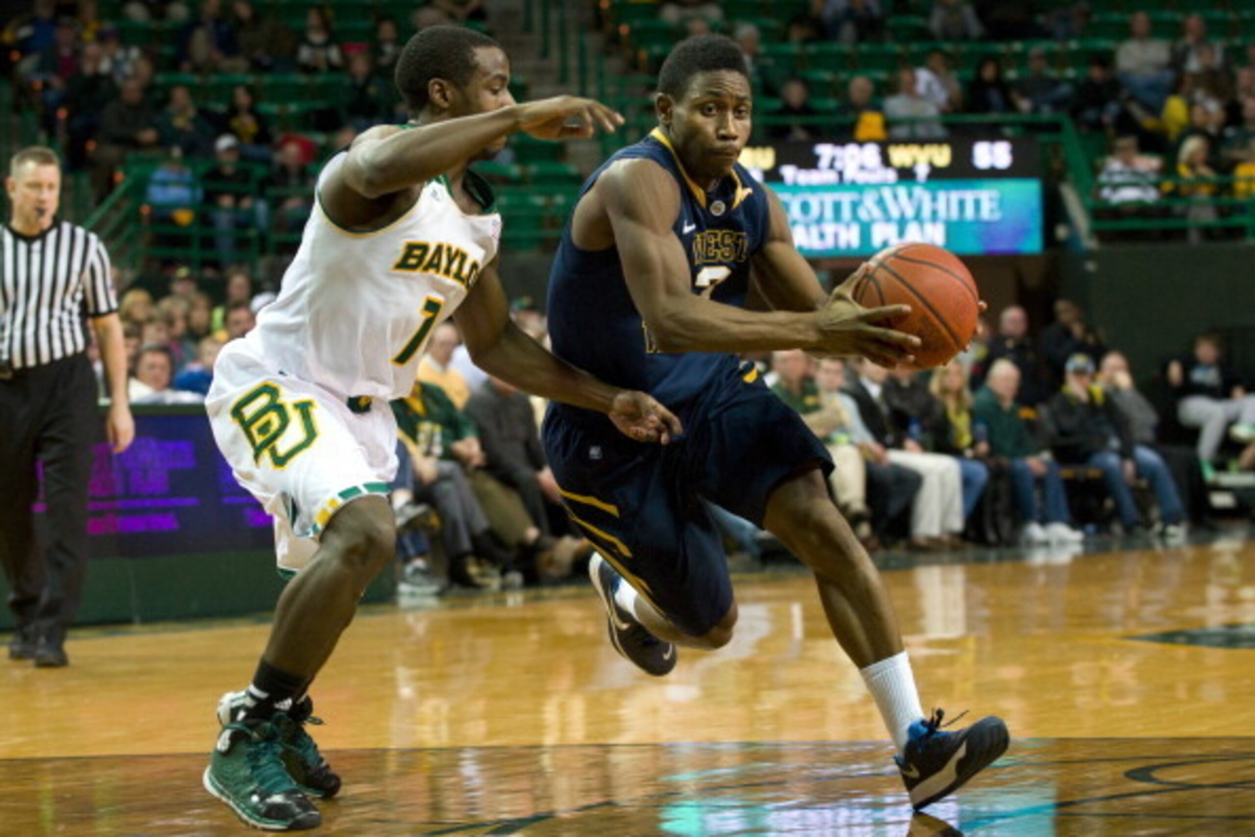 WACO, TX - JANUARY 28:  Juwan Staten #3 of the West Virginia Mountaineers drives to the basket past Kenny Chery #1 of the Baylor Bears on January 28, 2014 at the Ferrell Center in Waco, Texas.  (Photo by Cooper Neill/Getty Images)