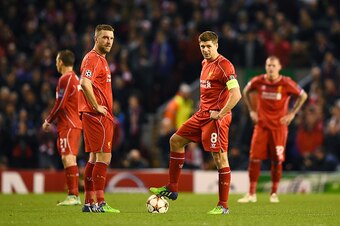 LIVERPOOL, ENGLAND - DECEMBER 09: (R-L) Dejected Liverpool players Rickie Lambert and Steven Gerrard look on after conceding the opening goal during the UEFA Champions League group B match between Liverpool and FC Basel 1893 at Anfield on December 9, 2014