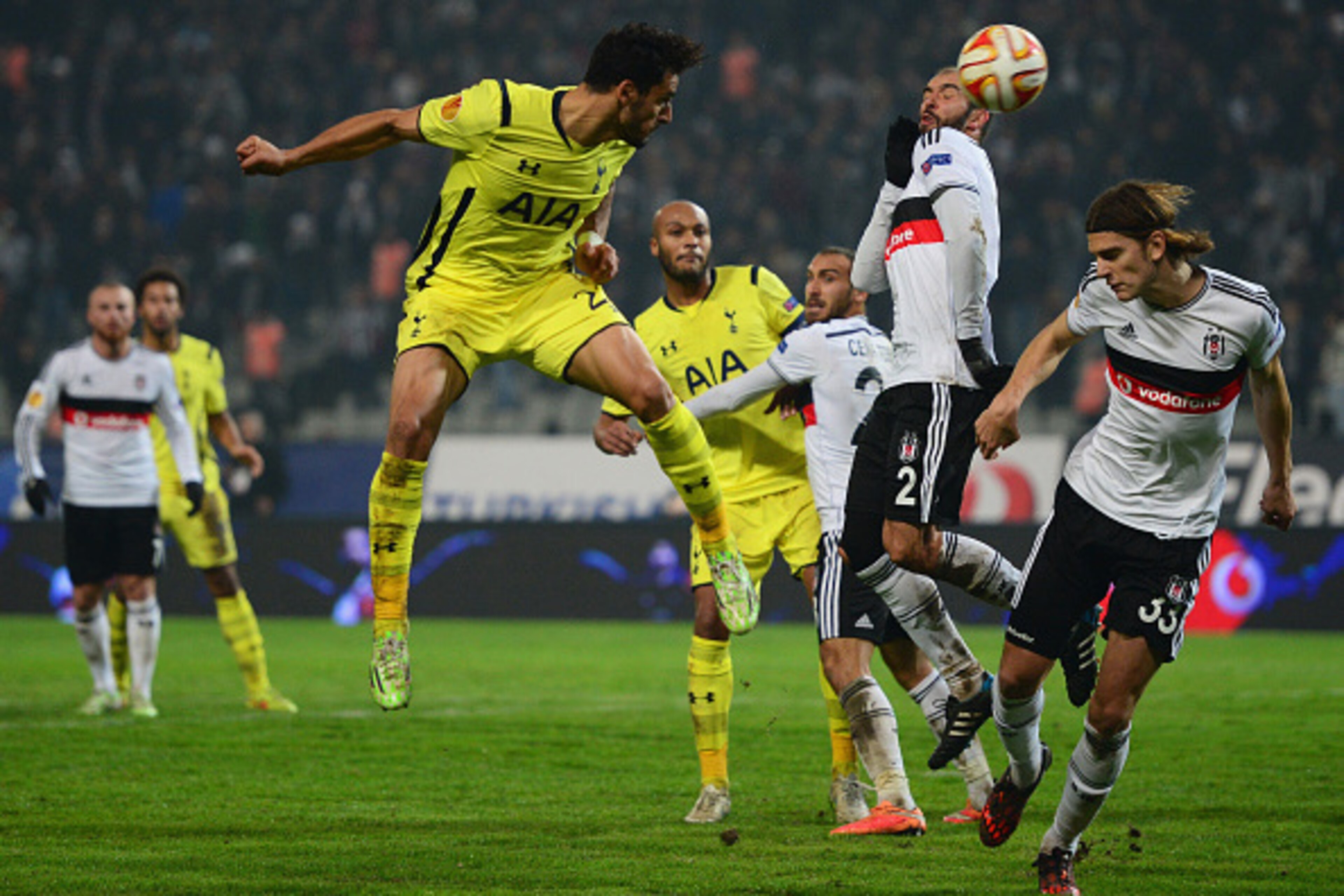 ISTANBUL, TURKEY - DECEMBER 11: Nacer Chadli of Spurs (L) heads at goal past Serdar Kurtulus (2) and Atinc Nukan of Besiktas (33) during the UEFA Europa League Group C match between Besiktas JK and Tottenham Hotspur FC at Ataturk Olympic Stadium on Decem ISTANBUL, TURKEY - DECEMBER 11: Nacer Chadli of Spurs (L) heads at goal past Serdar Kurtulus (2) and Atinc Nukan of Besiktas (33) during the UEFA Europa League Group C match between Besiktas JK and Tottenham Hotspur FC at Ataturk Olympic Stadium on Decem