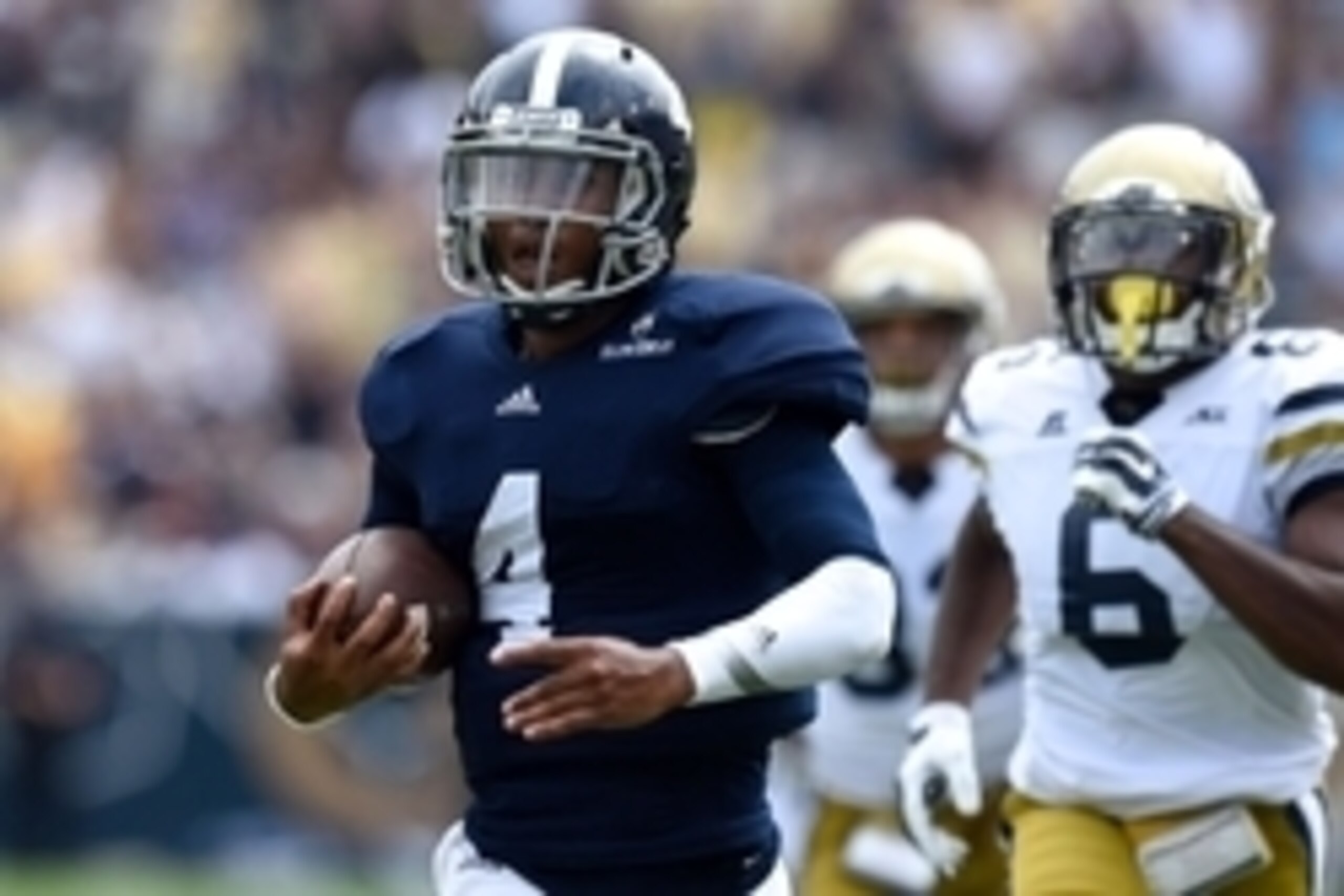 Sep 13, 2014; Atlanta, GA, USA; Georgia Southern Eagles quarterback Kevin Ellison (4) runs for a touchdown against the Georgia Tech Yellow Jackets during the second half at Bobby Dodd Stadium. Georgia Tech defeated Georgia Southern 42-38. Mandatory Credit