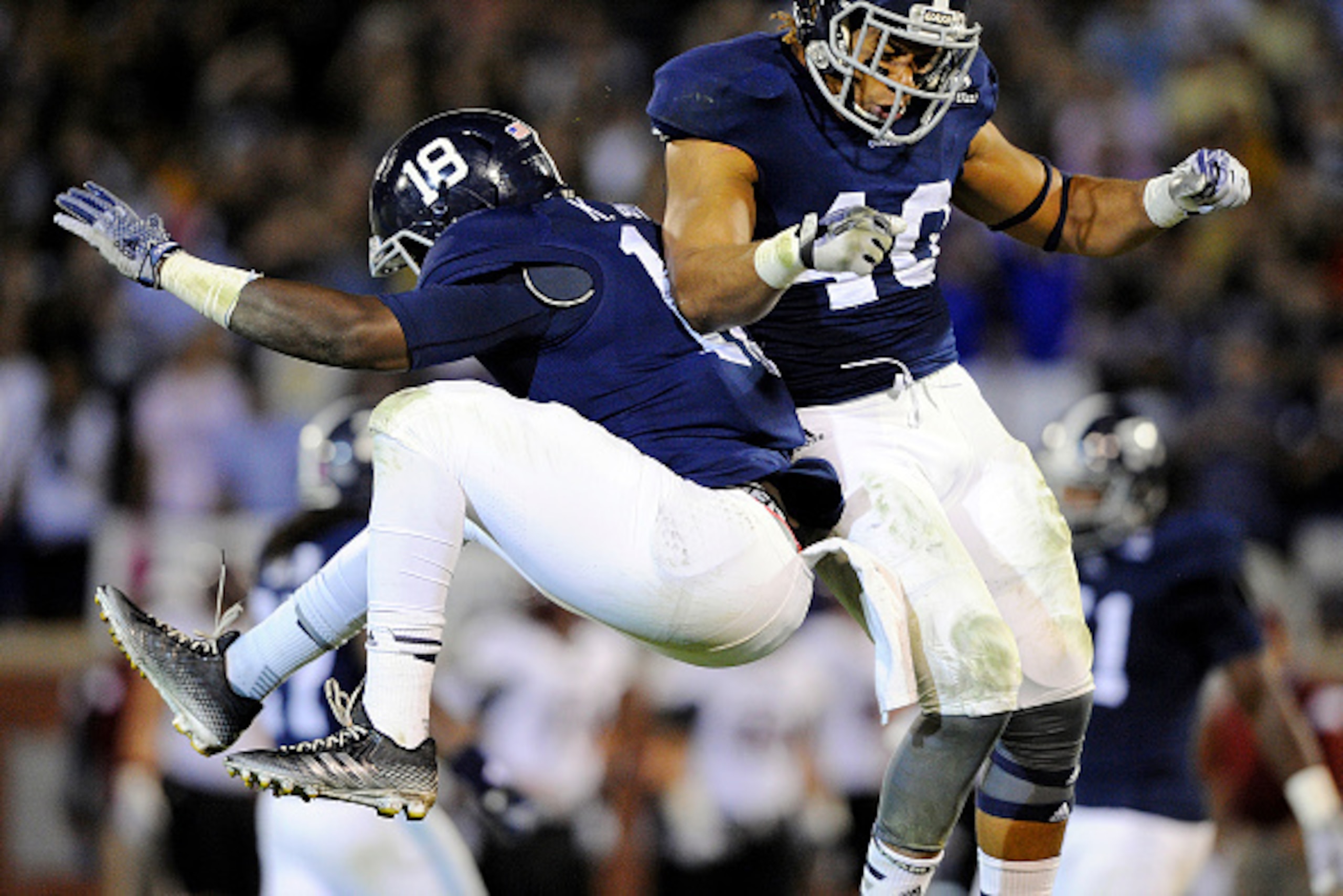 STATESBORO, GA - OCTOBER 30:  Linebacker Ken Butler #18 and linebacker Edwin Jackson #40 of the Georgia Southern Eagles celebrate a sack against the Troy Trojans during the second quarter on October 30, 2014 at Paulson Stadium in Statesboro, Georgia.  (Ph
