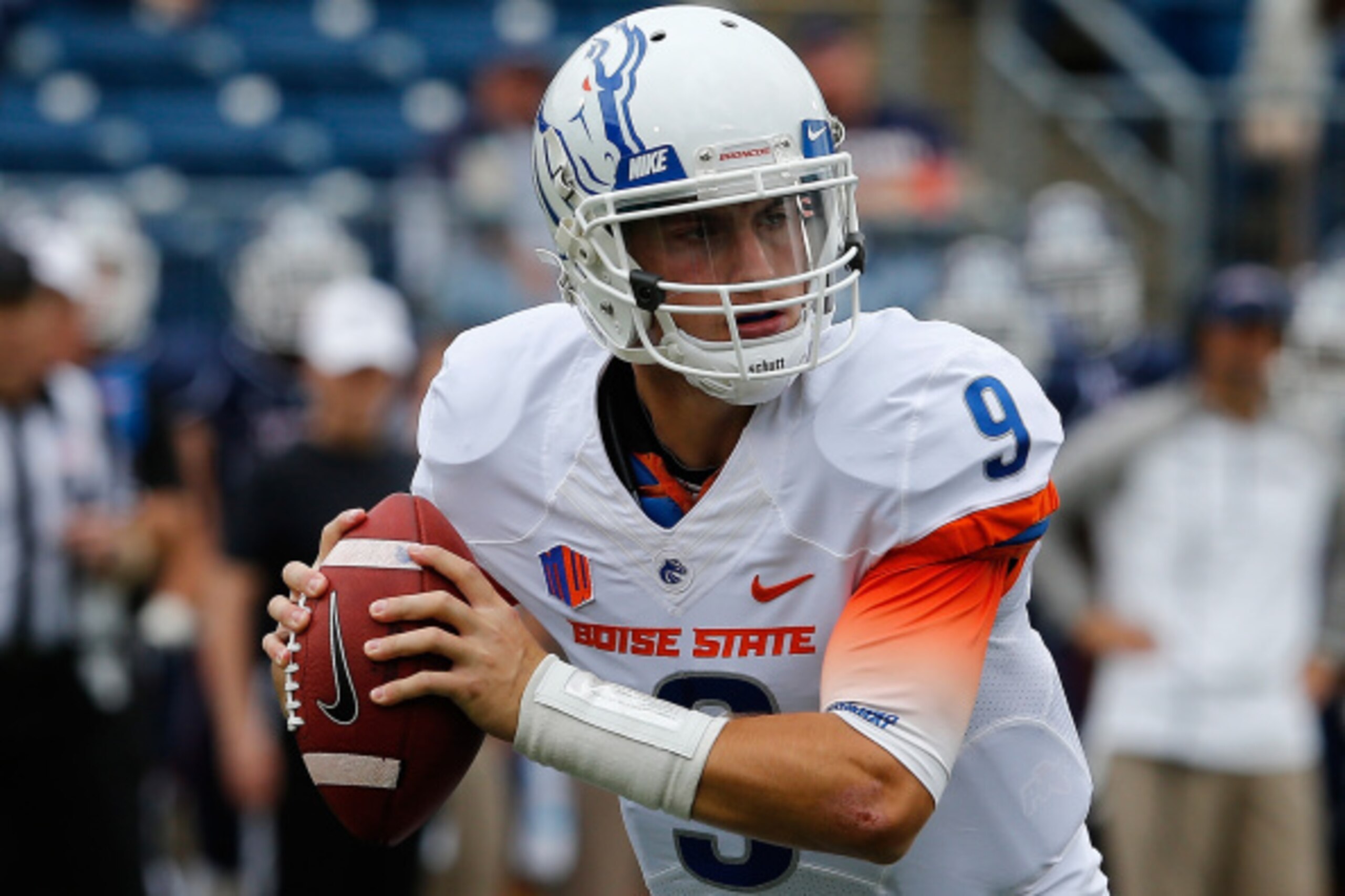 BOSTON, MA - SEPTEMBER 13:   Grant Hedrick #9 of the Boise State Broncos looks for an open man against the Connecticut Huskies  in the first quarter at Rentschler Field on September 13, 2014 in East Hartford, Connecticut. (Photo by Jim Rogash/Getty Images