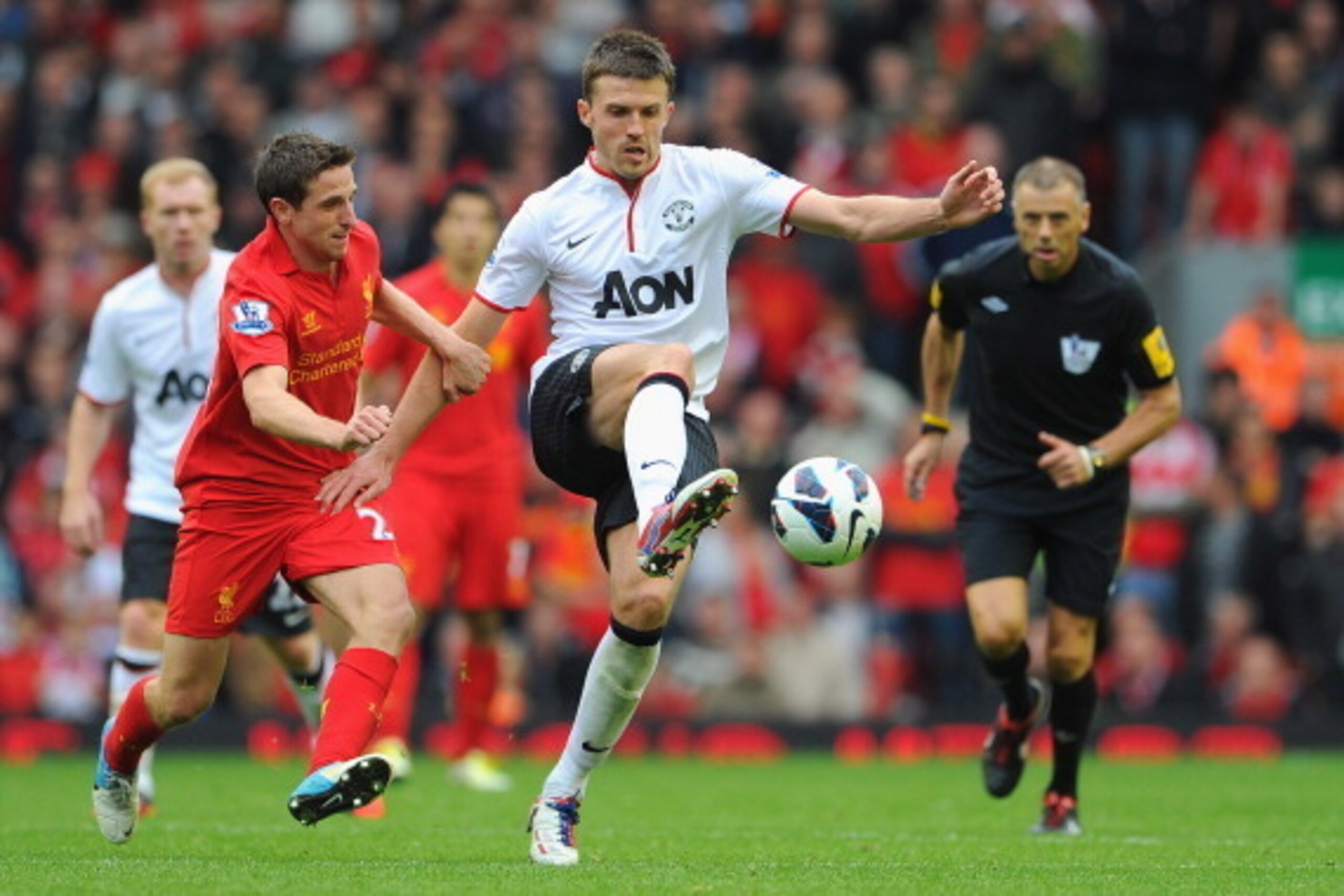 LIVERPOOL, ENGLAND - SEPTEMBER 23: Joe Allen of Liverpool in action with Michael Carrick of Manchester United during the Barclays Premier League match between Liverpool and Manchester United at Anfield on September 23, 2012 in Liverpool, England. (Photo LIVERPOOL, ENGLAND - SEPTEMBER 23: Joe Allen of Liverpool in action with Michael Carrick of Manchester United during the Barclays Premier League match between Liverpool and Manchester United at Anfield on September 23, 2012 in Liverpool, England. (Photo