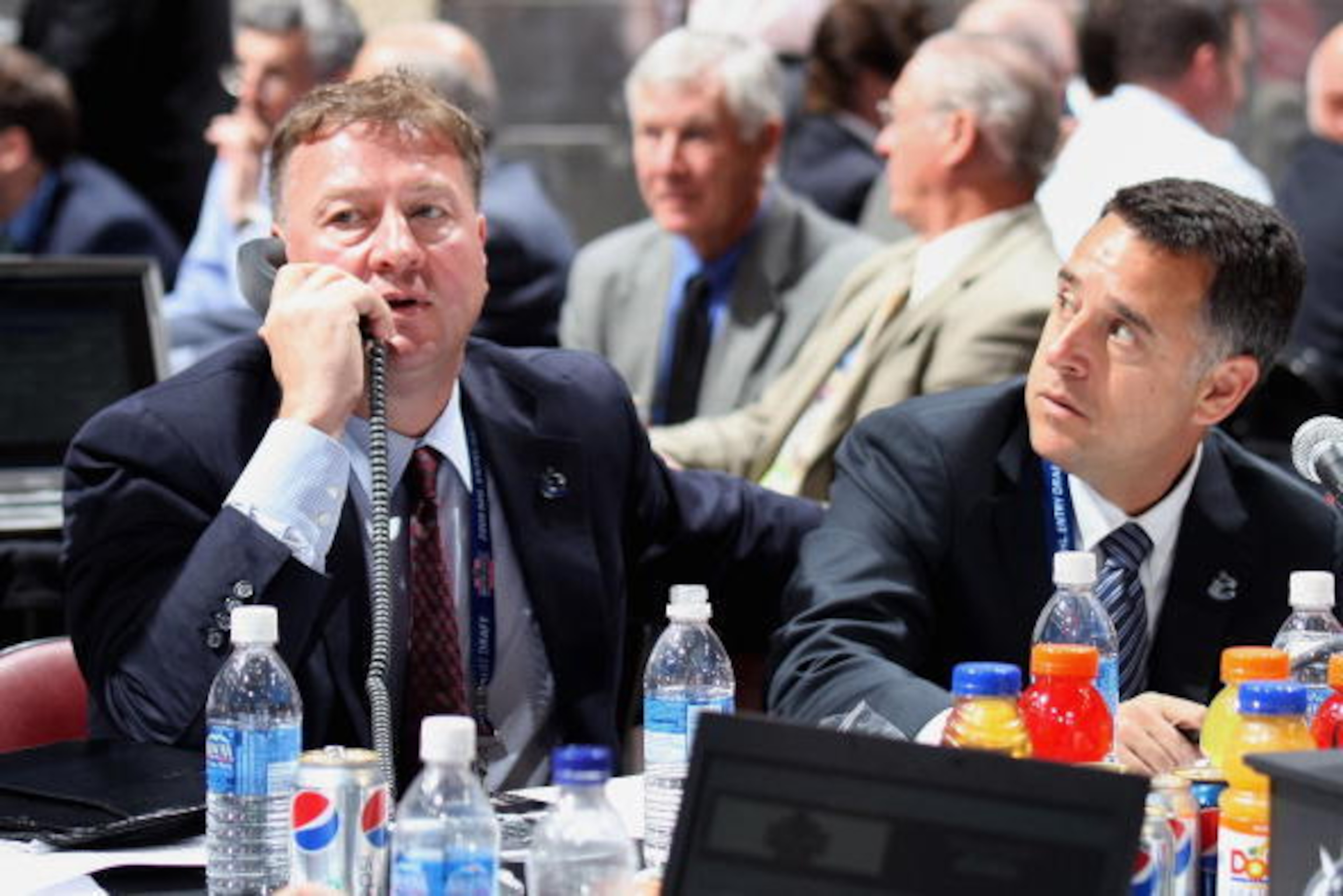 MONTREAL, QC - JUNE 27:  (L-R) General Manager Mike Gillis and assistant General Manager Laurence Gilman of the Vancouver Canucks sit at the draft table during the 2009 NHL Entry Draft at the Bell Centre on June 27, 2009 in Montreal, Quebec, Canada. (Phot